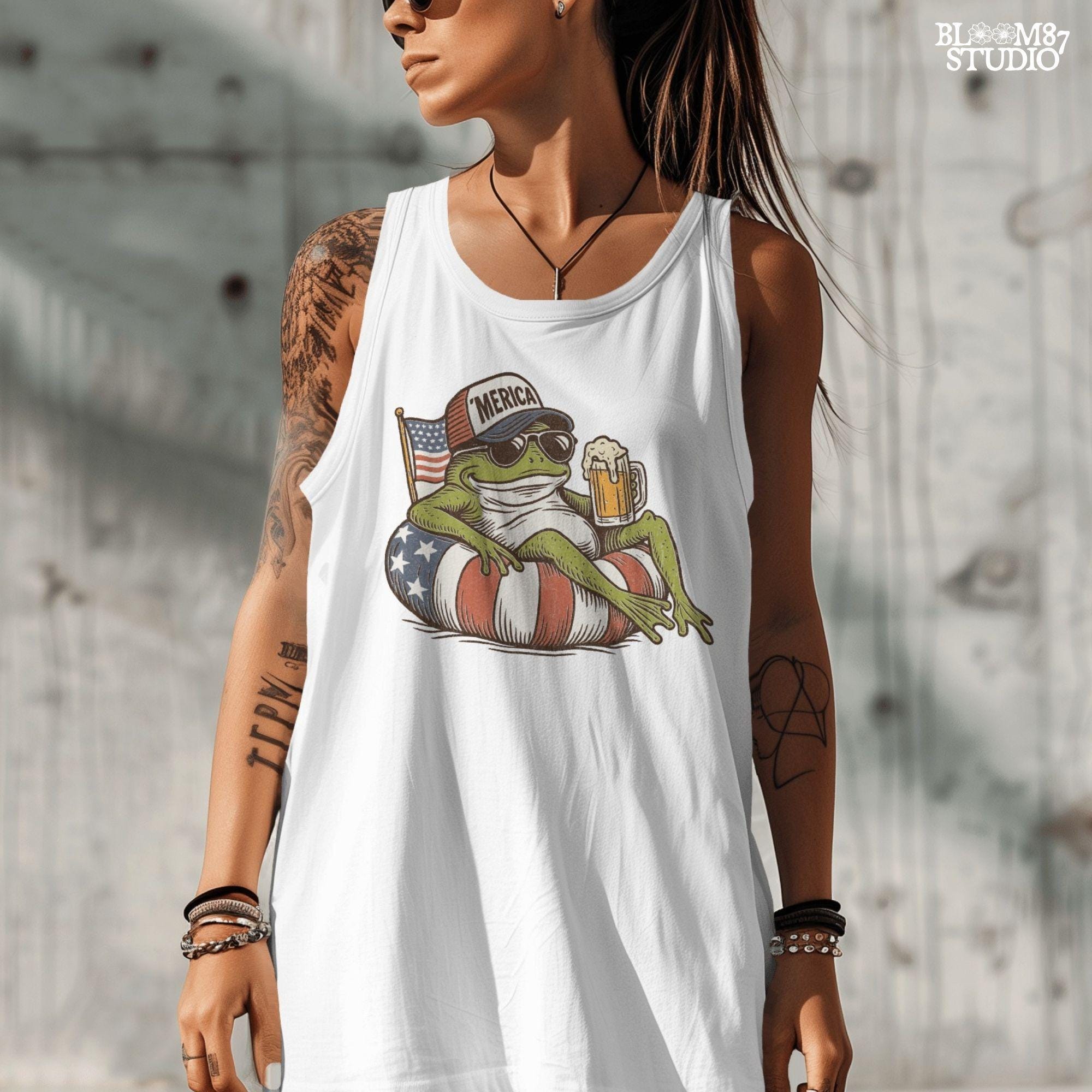 A vintage-style cartoon frog lounging on a patriotic inner tube, wearing a ‘Merica cap and sunglasses, holding a mug of beer with an American flag in the background.