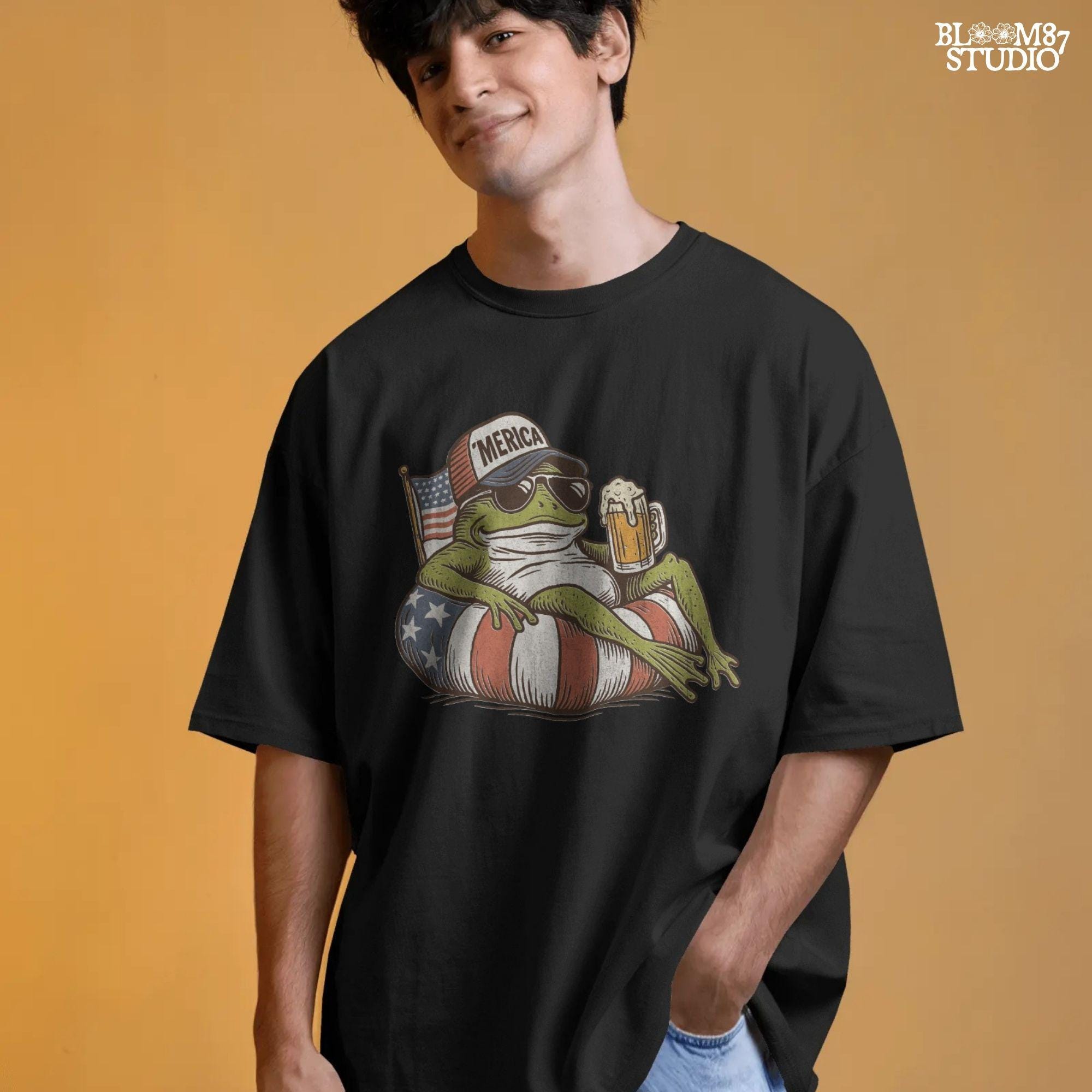 A vintage-style cartoon frog lounging on a patriotic inner tube, wearing a ‘Merica cap and sunglasses, holding a mug of beer with an American flag in the background.