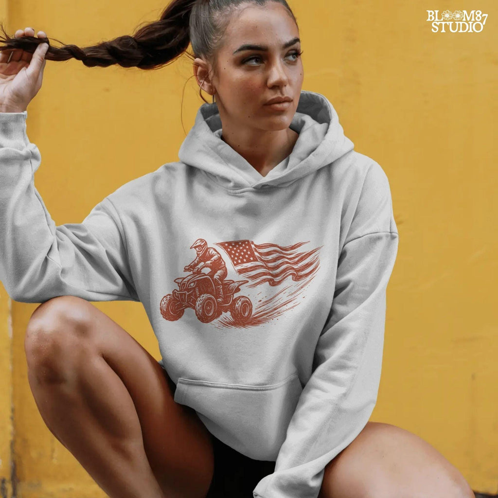 Hand-drawn illustration of a 4-wheeler racing ATV rider waving an American flag, evoking patriotic off-road adventure and freedom.