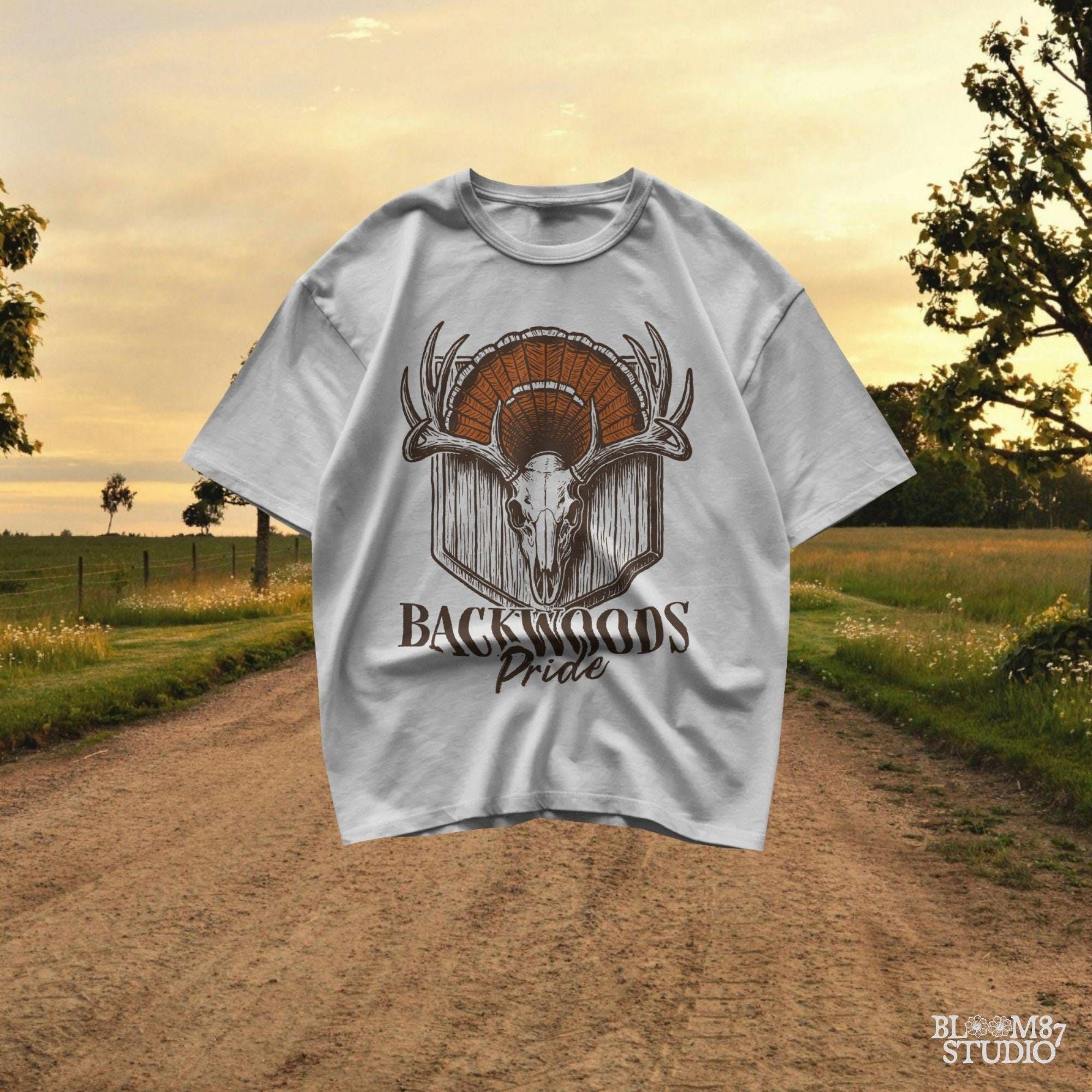 Rustic design of a deer skull with antlers and a turkey fan backdrop above the words “Backwoods Pride,” perfect for country and hunting themes.