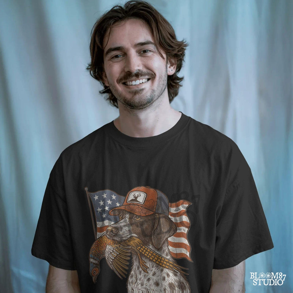Hunting dog wearing a cap and holding a pheasant in its mouth, with a waving American flag in the background.