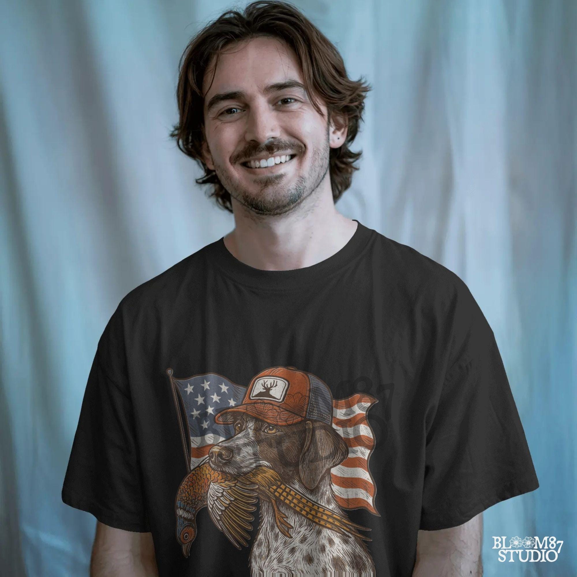 Hunting dog wearing a cap and holding a pheasant in its mouth, with a waving American flag in the background.