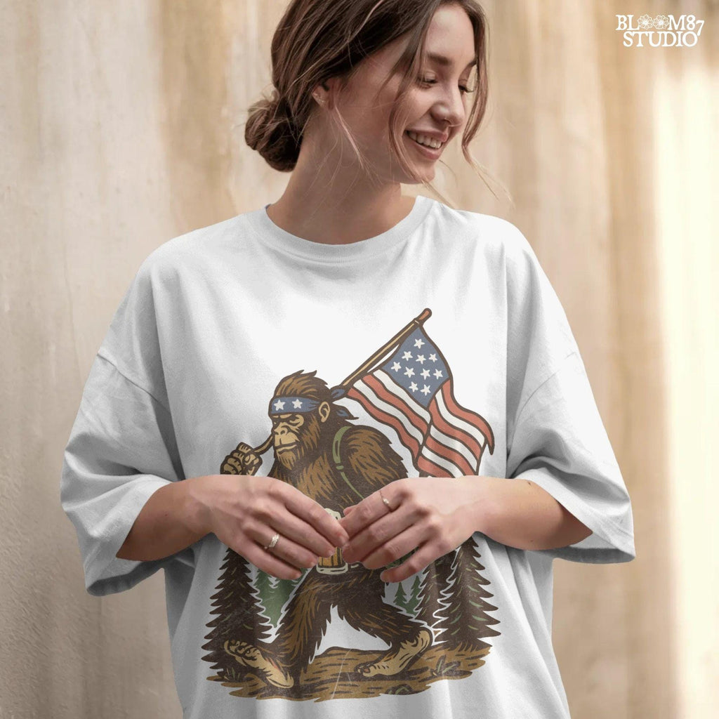 Patriotic bigfoot carrying American flag and beer mug in forest, funny summer USA PNG design.