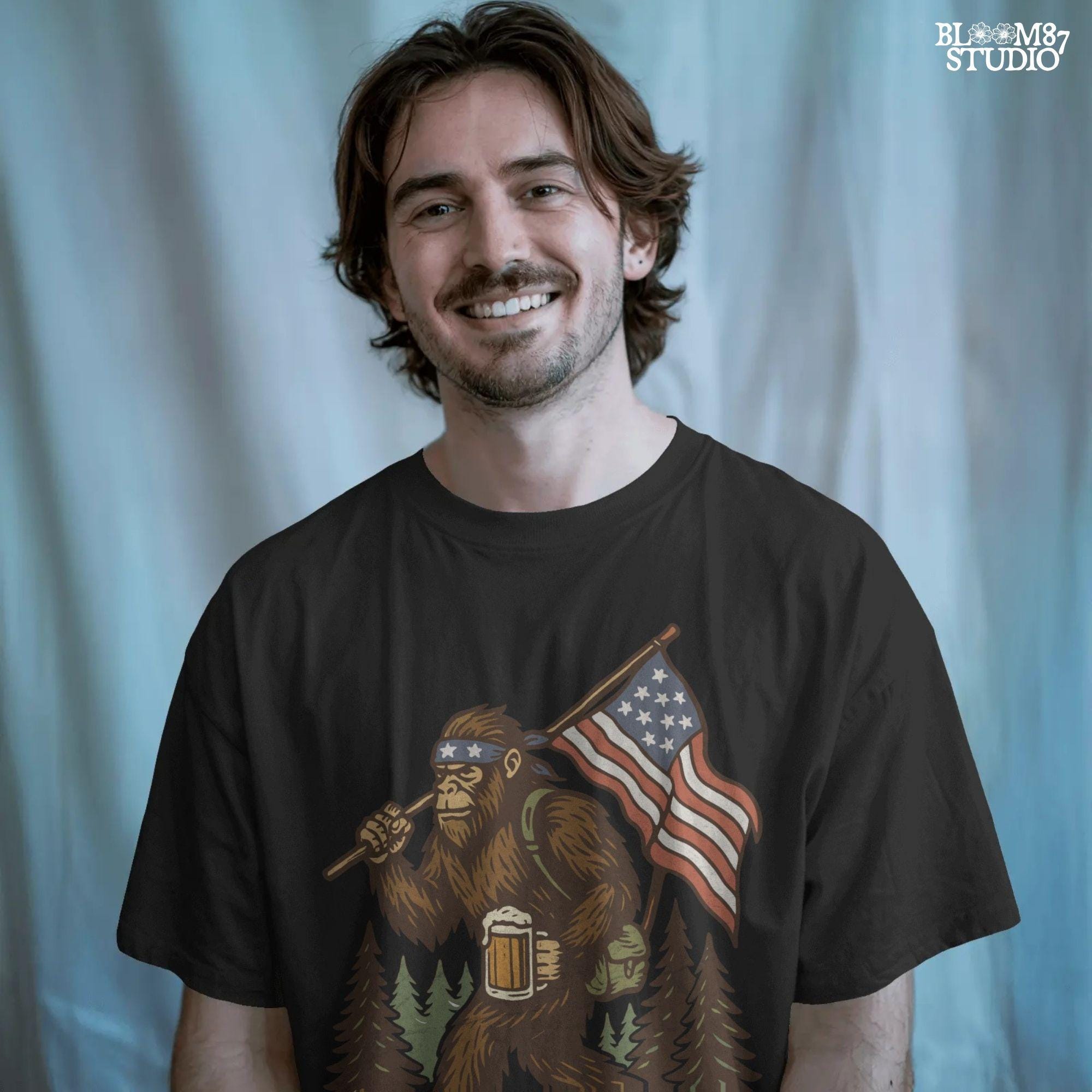 Patriotic bigfoot carrying American flag and beer mug in forest, funny summer USA PNG design.