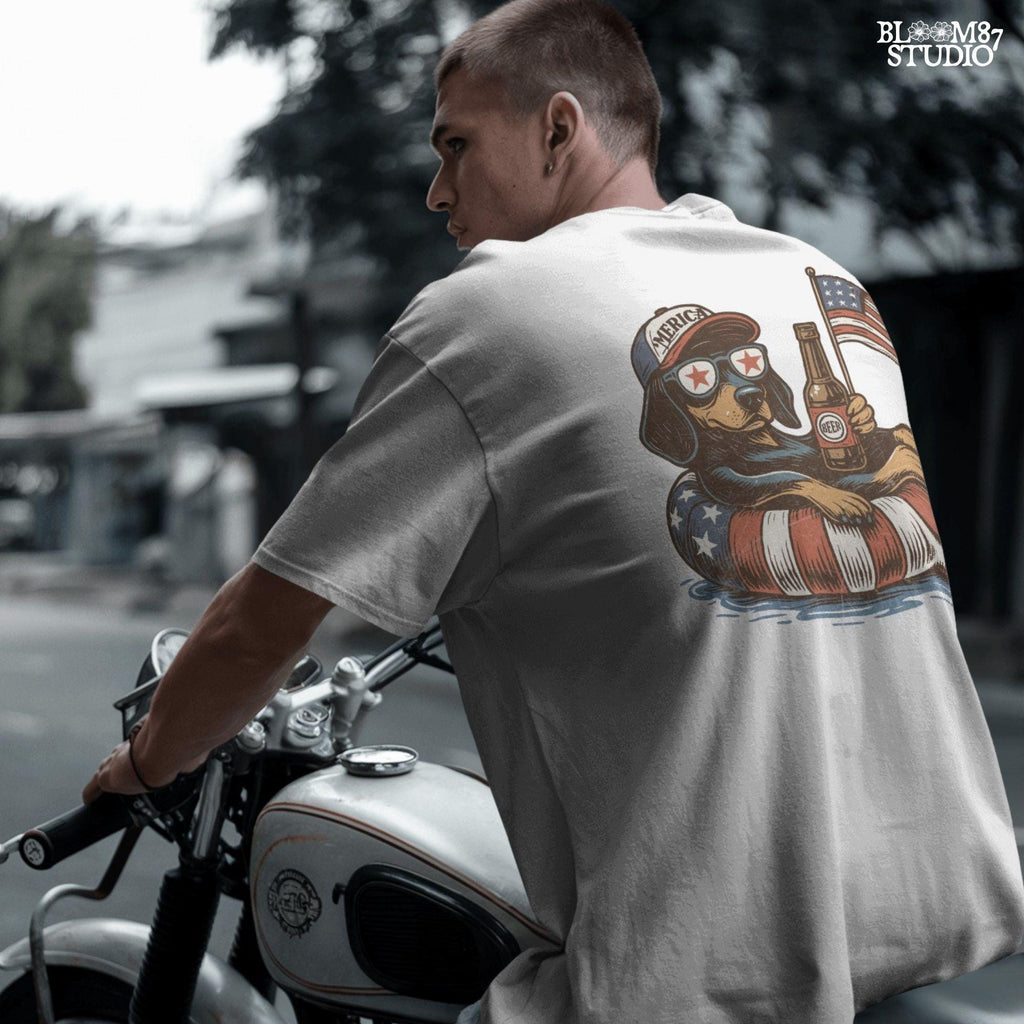 Funny patriotic dachshund dog floating in pool with American flag inner tube, wearing USA sunglasses and holding beer bottle.