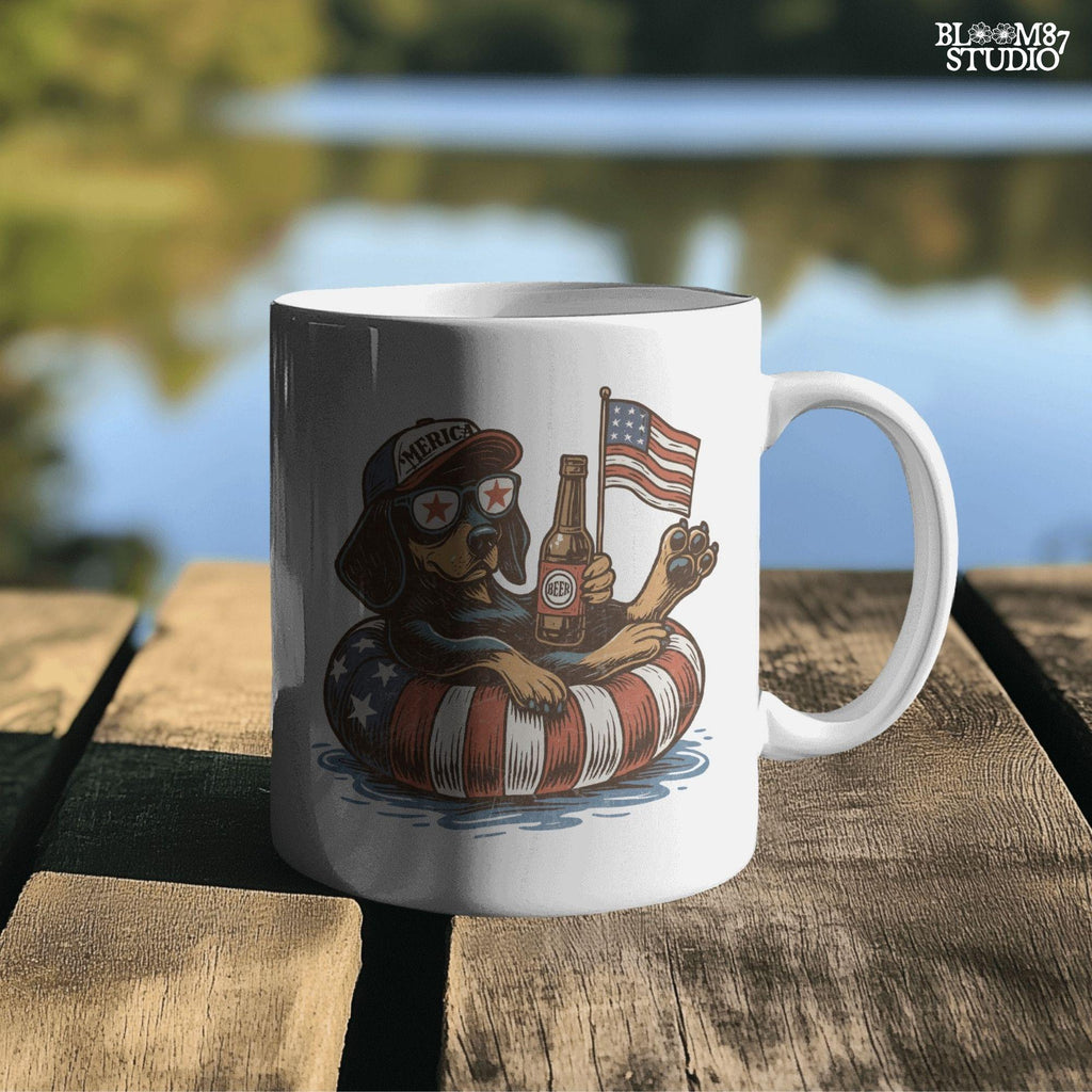 Funny patriotic dachshund dog floating in pool with American flag inner tube, wearing USA sunglasses and holding beer bottle.