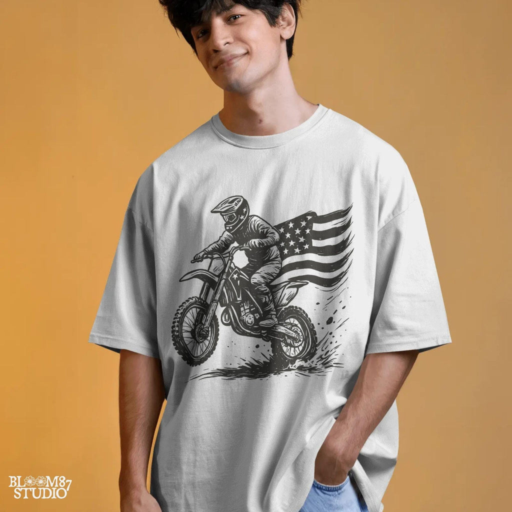 Patriotic motocross rider doing a dirt jump on a dirt bike with the American flag flowing behind, in a bold western vintage style illustration.
