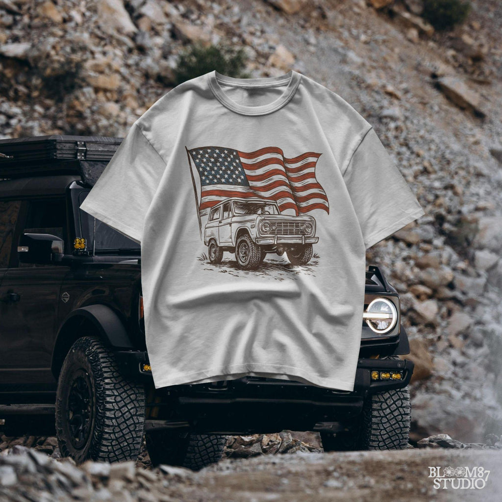 Vintage Bronco 4x4 truck with a waving rustic American flag in the background, drawn in a rugged western style with patriotic colors.