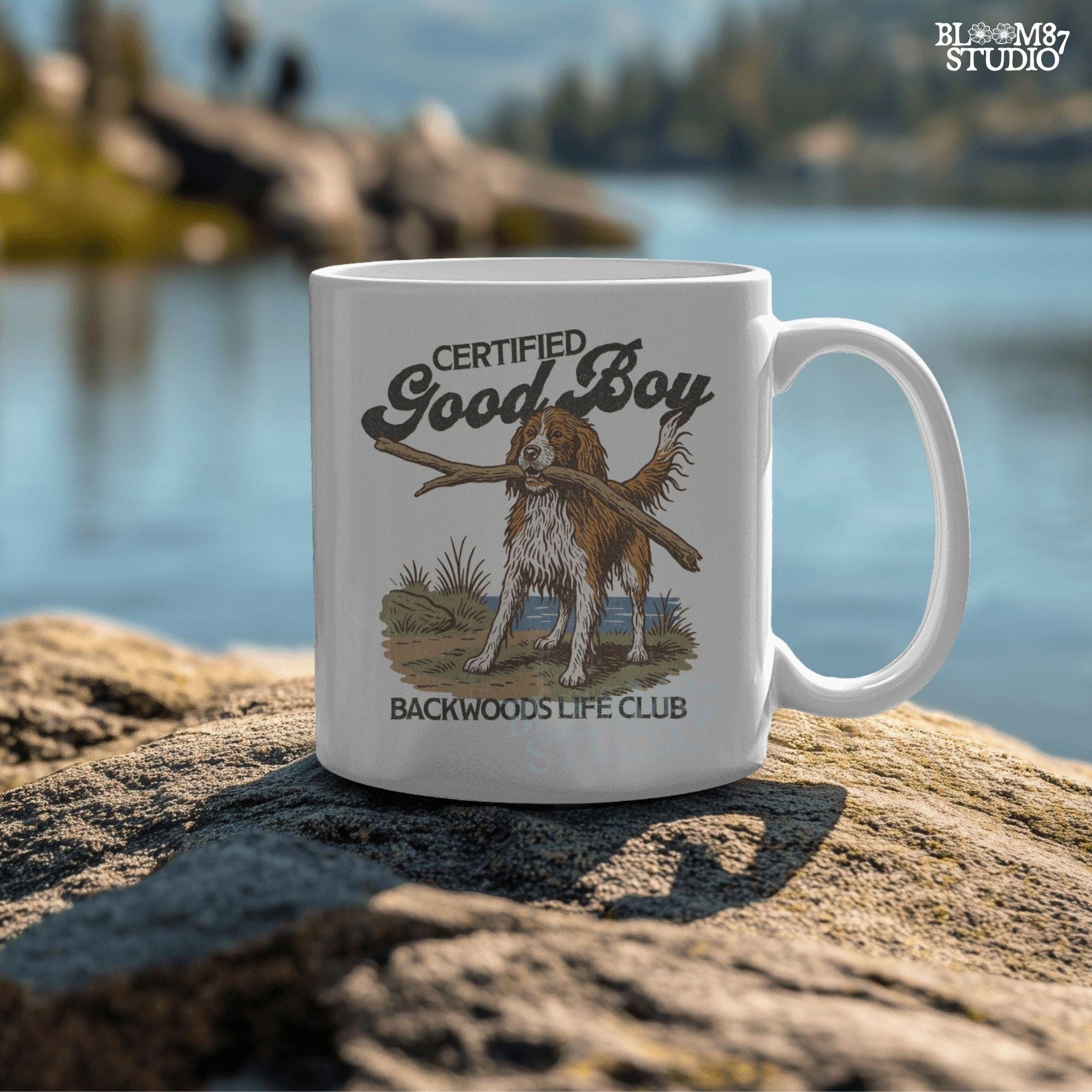 Brittany Spaniel dog holding a stick with text Certified Good Boy and Backwoods Life Club, rustic hunting dog art