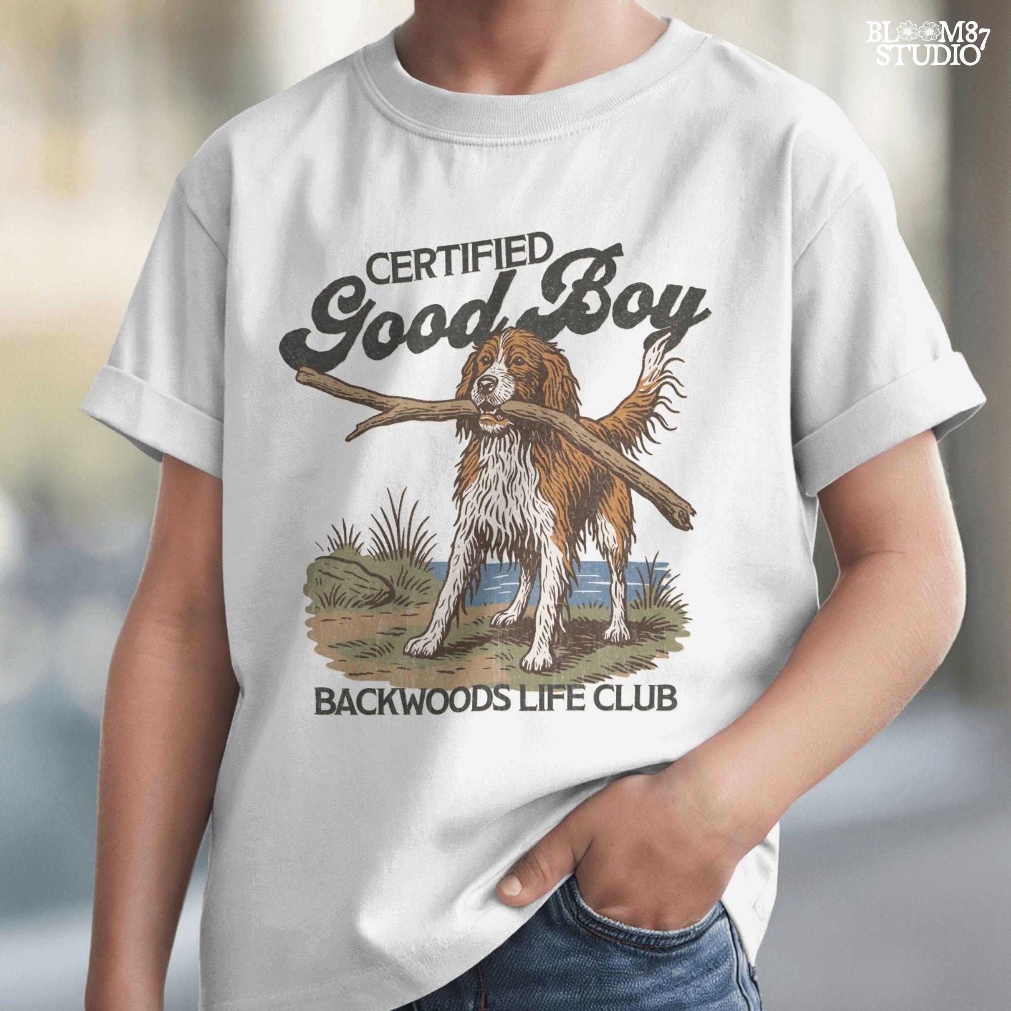 Brittany Spaniel dog holding a stick with text Certified Good Boy and Backwoods Life Club, rustic hunting dog art