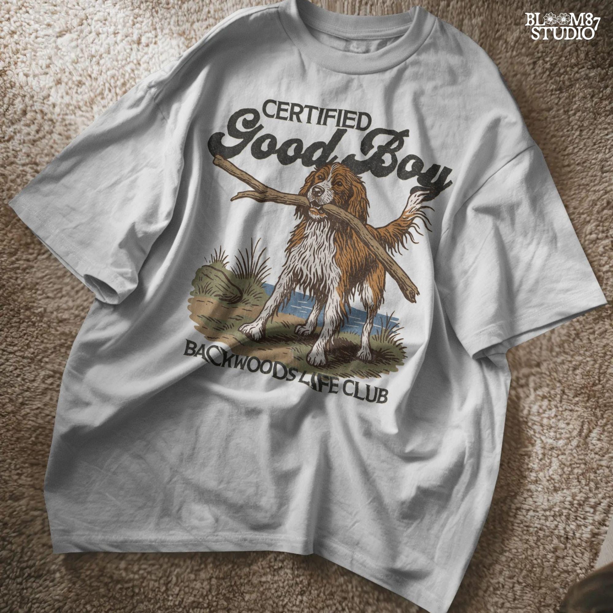 Brittany Spaniel dog holding a stick with text Certified Good Boy and Backwoods Life Club, rustic hunting dog art