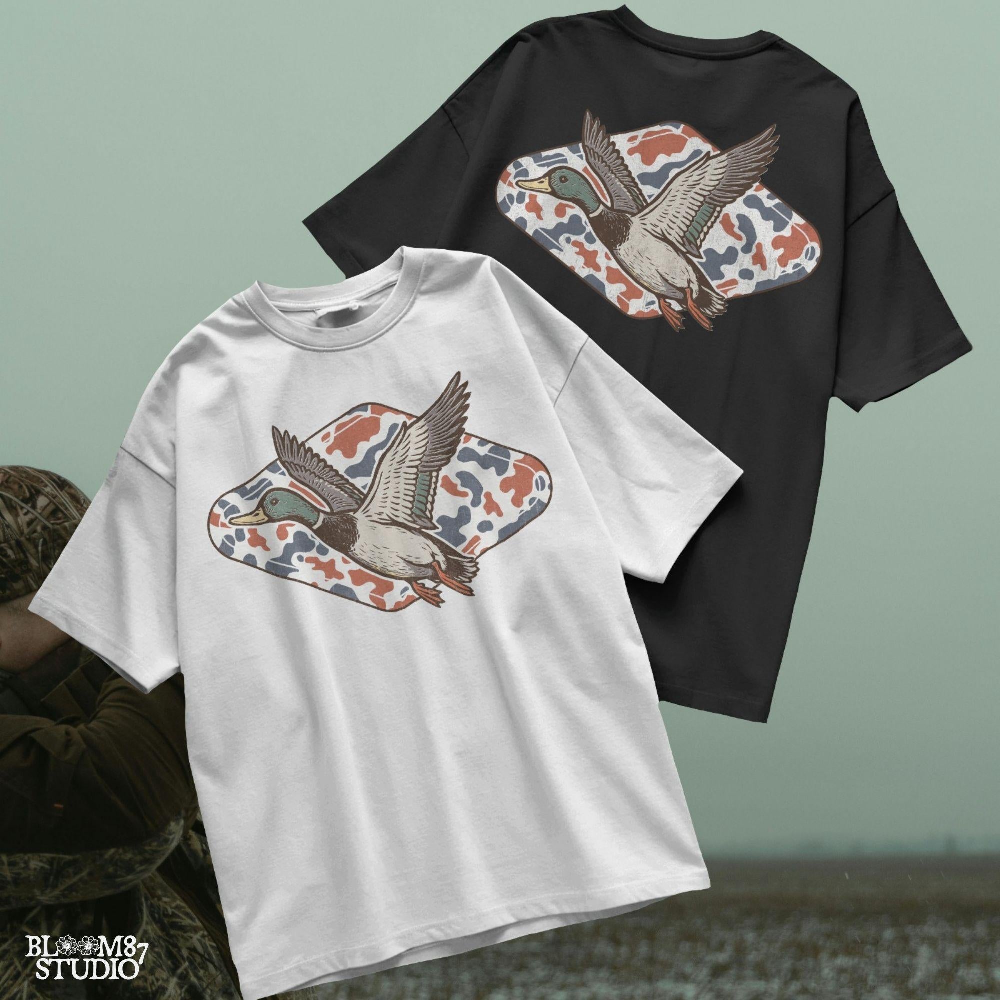 Mallard duck flying over a red, white, and blue camo background, patriotic hunting-themed PNG graphic for 4th of July projects.