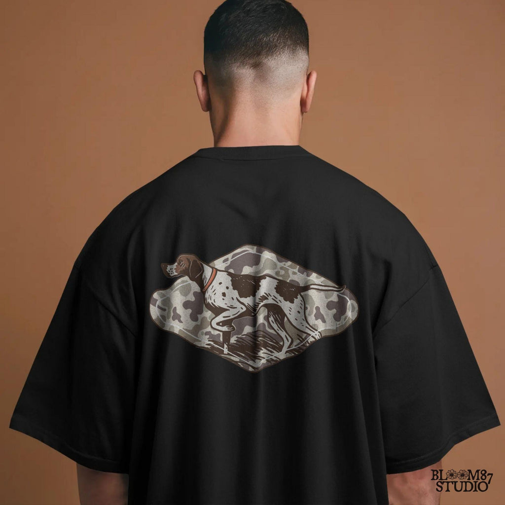 Illustration of a pointer hunting dog in a classic pointing stance on a vintage camo background, designed for upland hunting and outdoor-themed projects.