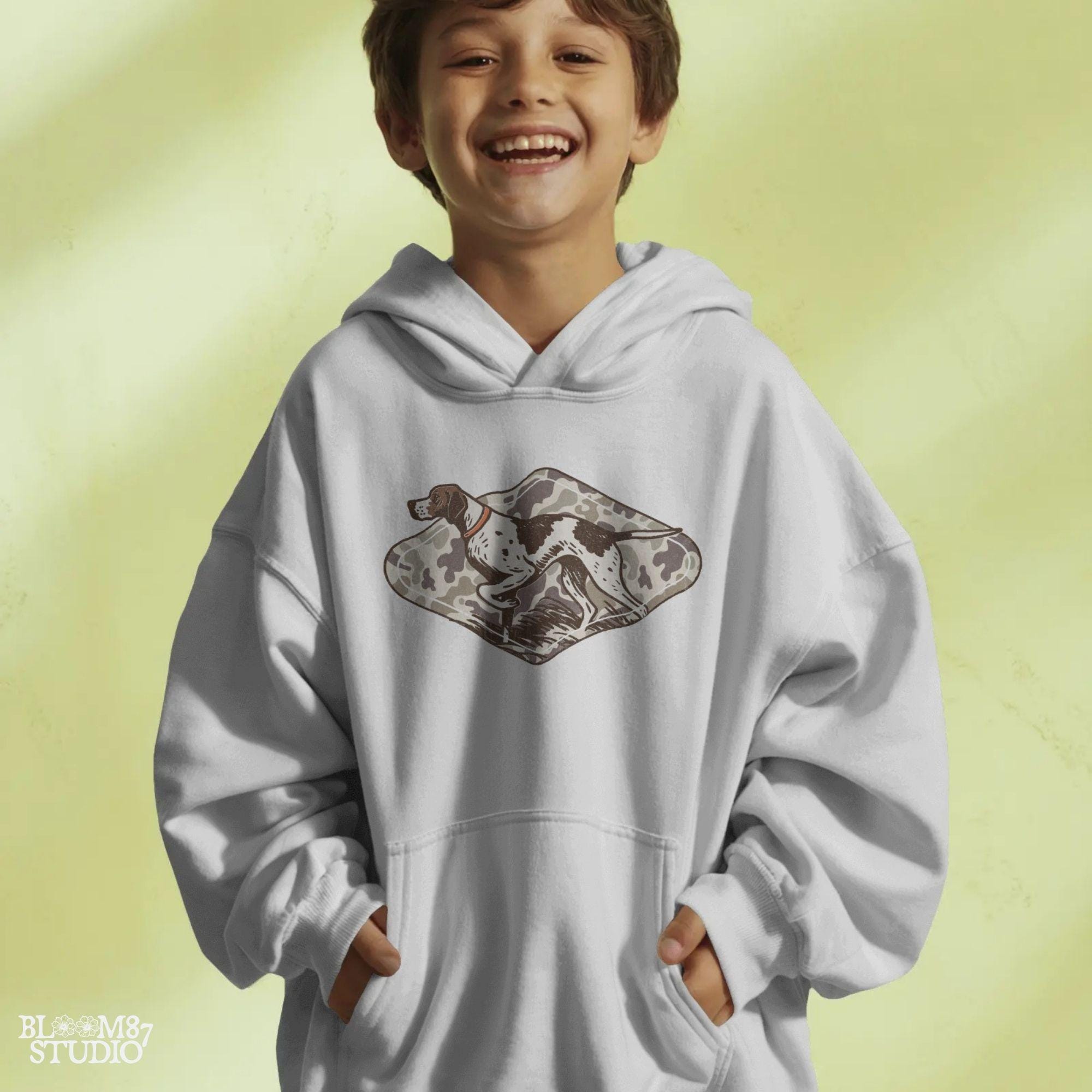 Illustration of a pointer hunting dog in a classic pointing stance on a vintage camo background, designed for upland hunting and outdoor-themed projects.