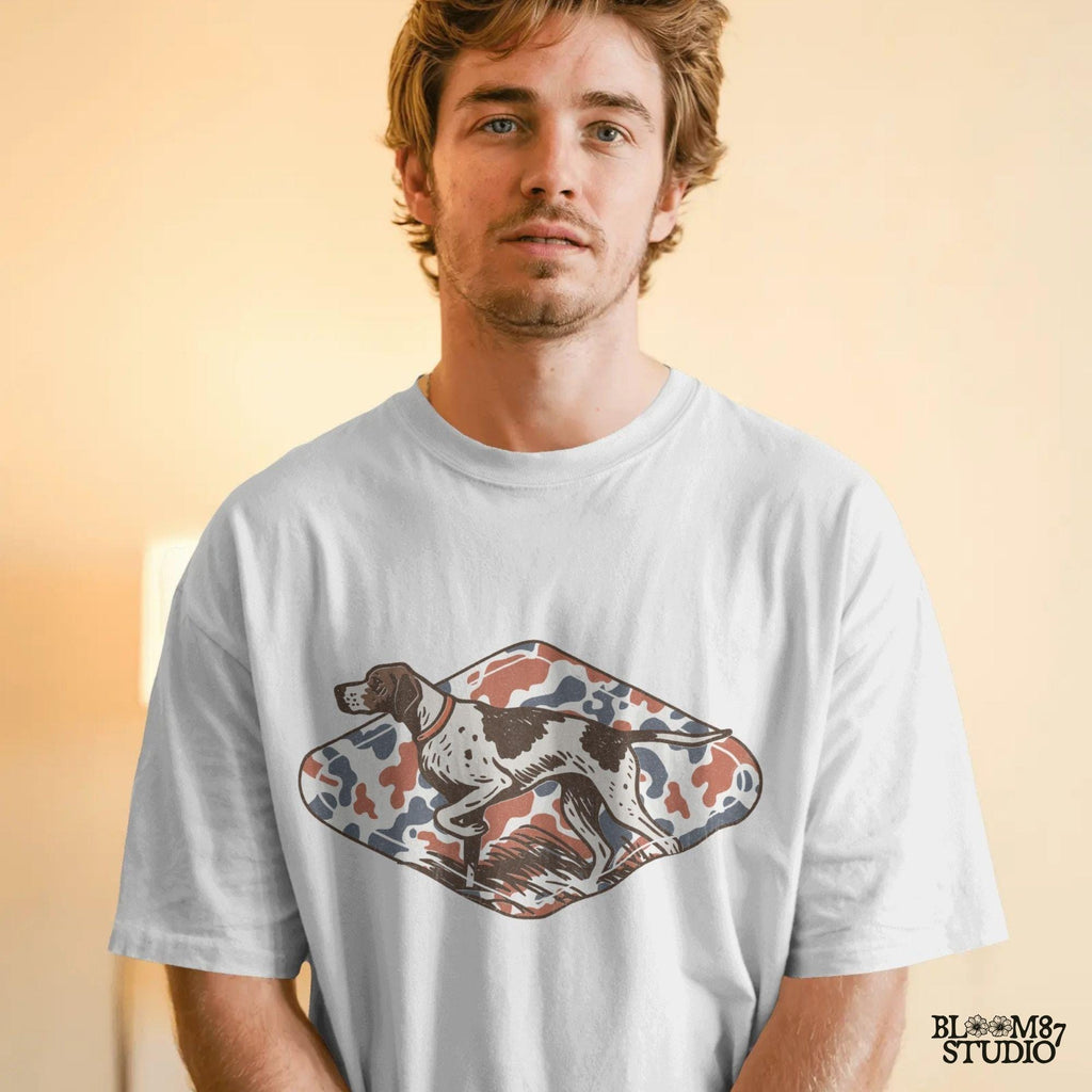 Patriotic illustration of a pointing hunting dog in red, white, and blue camo background, perfect for upland hunting fans and 4th of July projects.