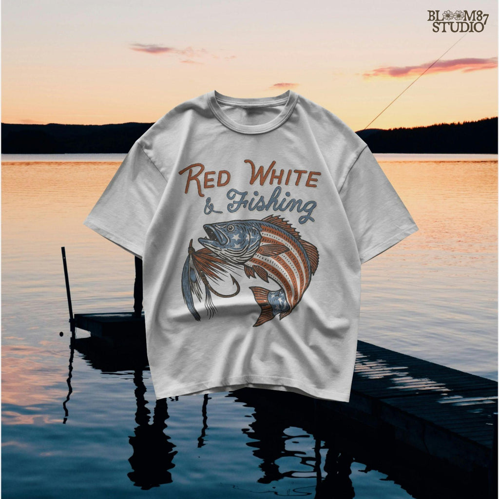 Bass fish decorated with American flag stars and stripes, jumping with a fishing lure and text “Red White & Fishing” in patriotic style.