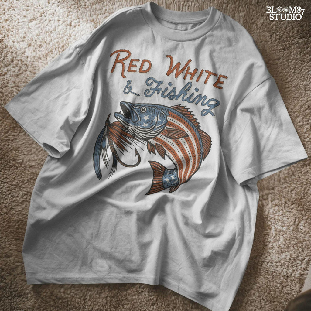 Bass fish decorated with American flag stars and stripes, jumping with a fishing lure and text “Red White & Fishing” in patriotic style.