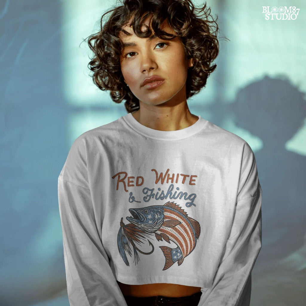 Bass fish decorated with American flag stars and stripes, jumping with a fishing lure and text “Red White & Fishing” in patriotic style.