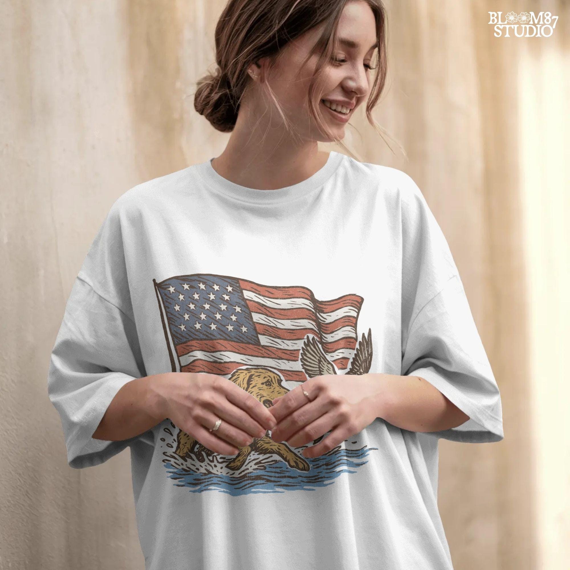 A yellow Labrador retriever splashing in water next to a flying duck, with a waving American flag in the background.