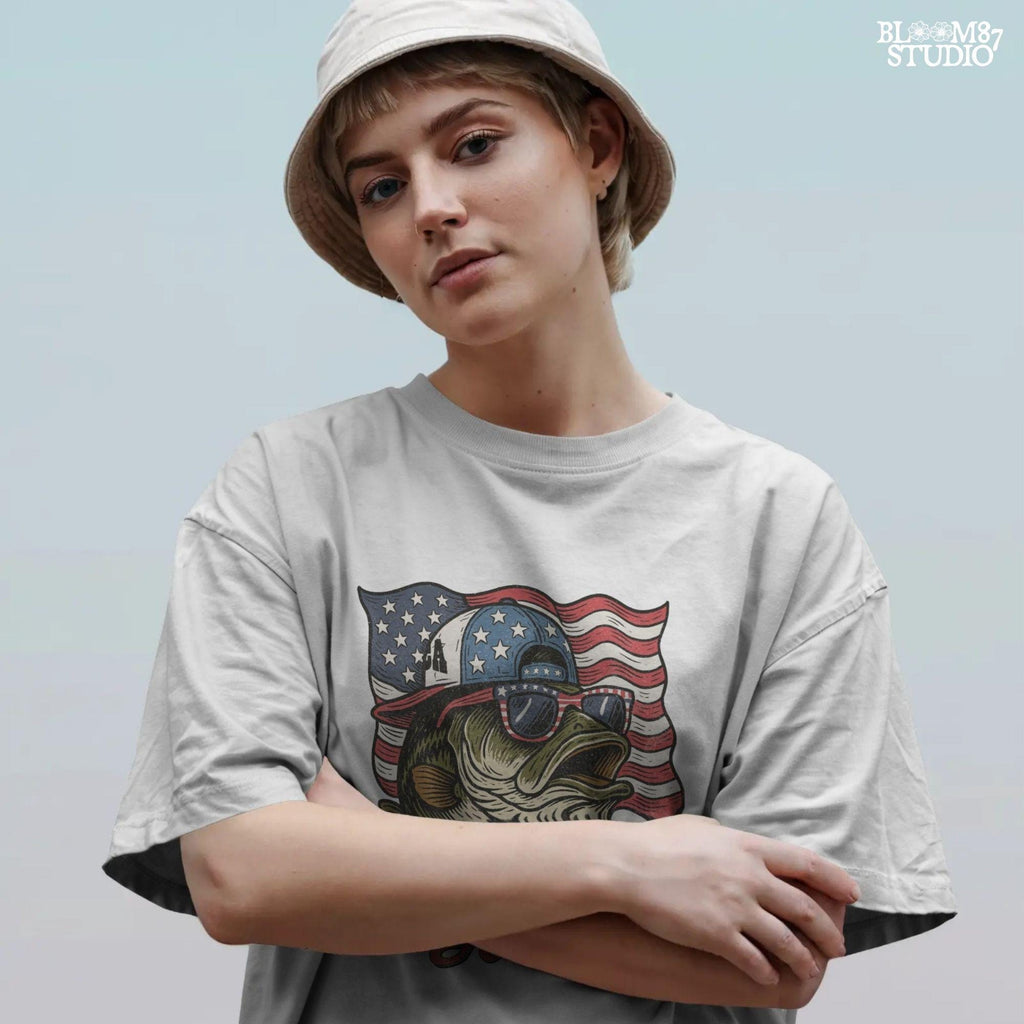 Patriotic cartoon largemouth bass wearing USA sunglasses and a hat in front of the American flag, with the text “American Hooker”.