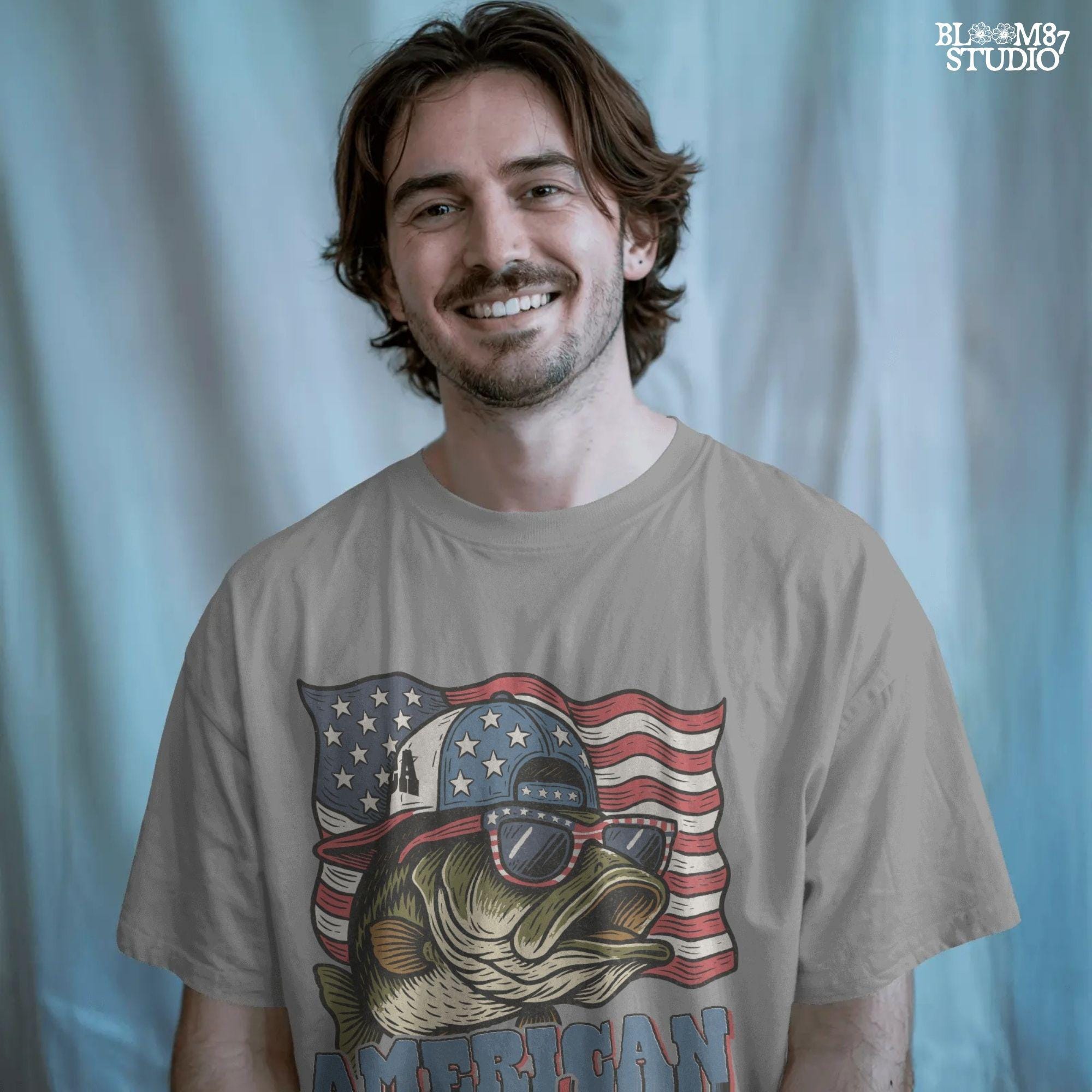 Patriotic cartoon largemouth bass wearing USA sunglasses and a hat in front of the American flag, with the text “American Hooker”.