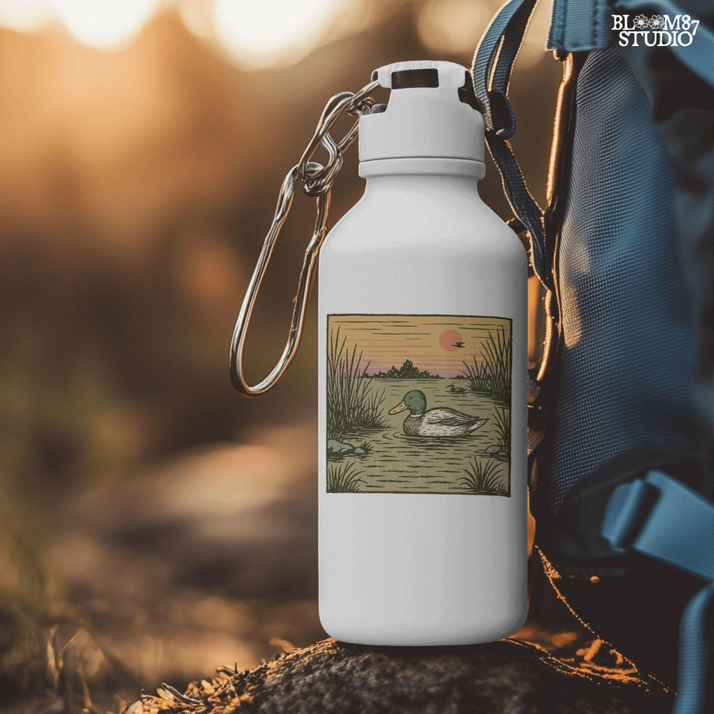 Illustration of a mallard duck swimming in a quiet pond at sunset, surrounded by reeds and a peaceful landscape in warm fall tones.