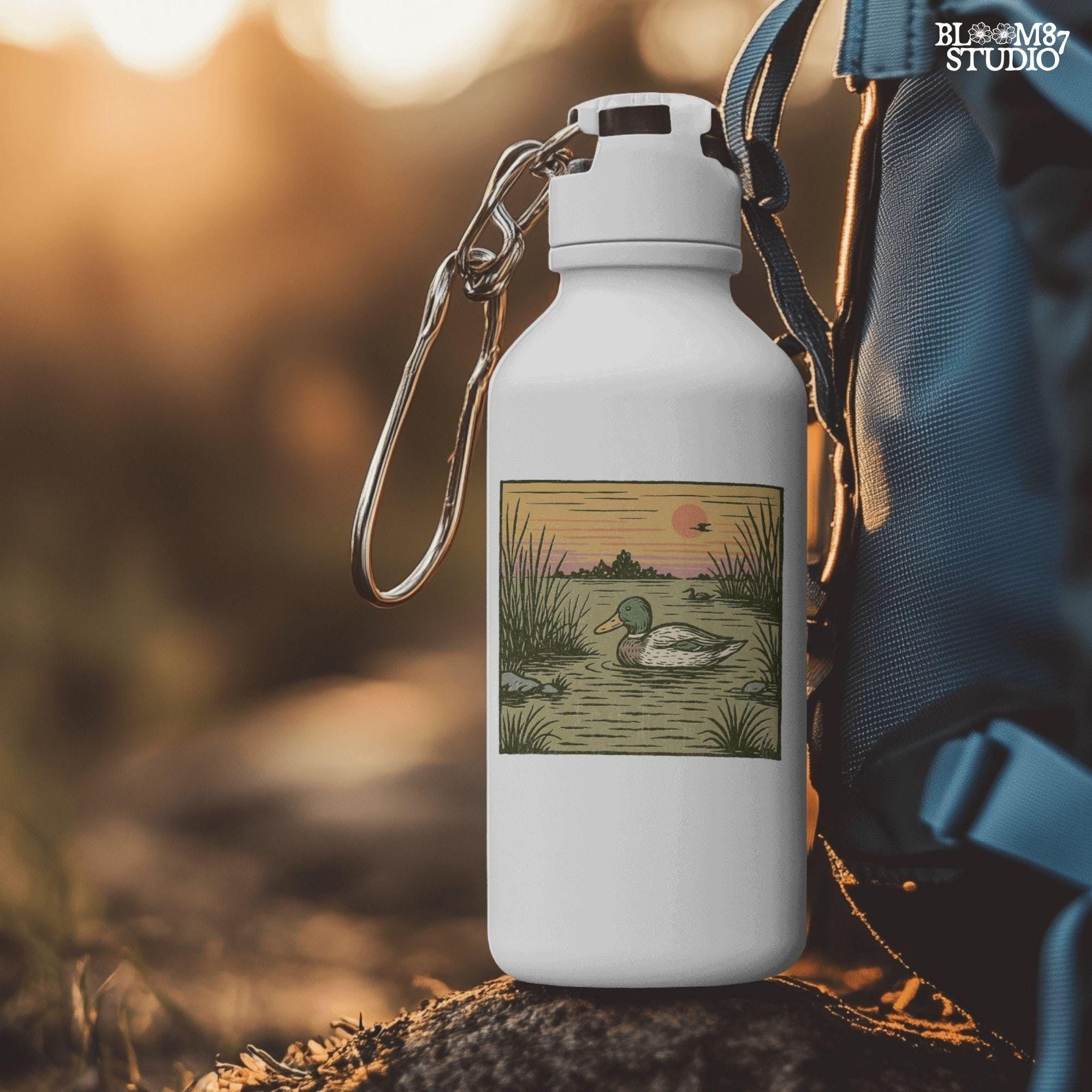 Illustration of a mallard duck swimming in a quiet pond at sunset, surrounded by reeds and a peaceful landscape in warm fall tones.