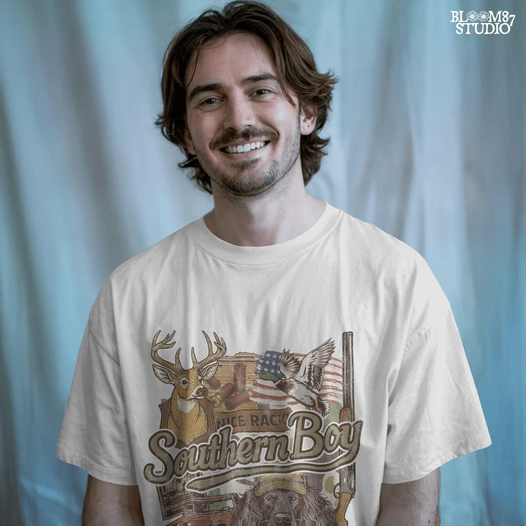 Collage-style design with deer, duck, hunting dog, vintage truck, shotgun, and camo background with the phrase “Southern Boy” in bold script.