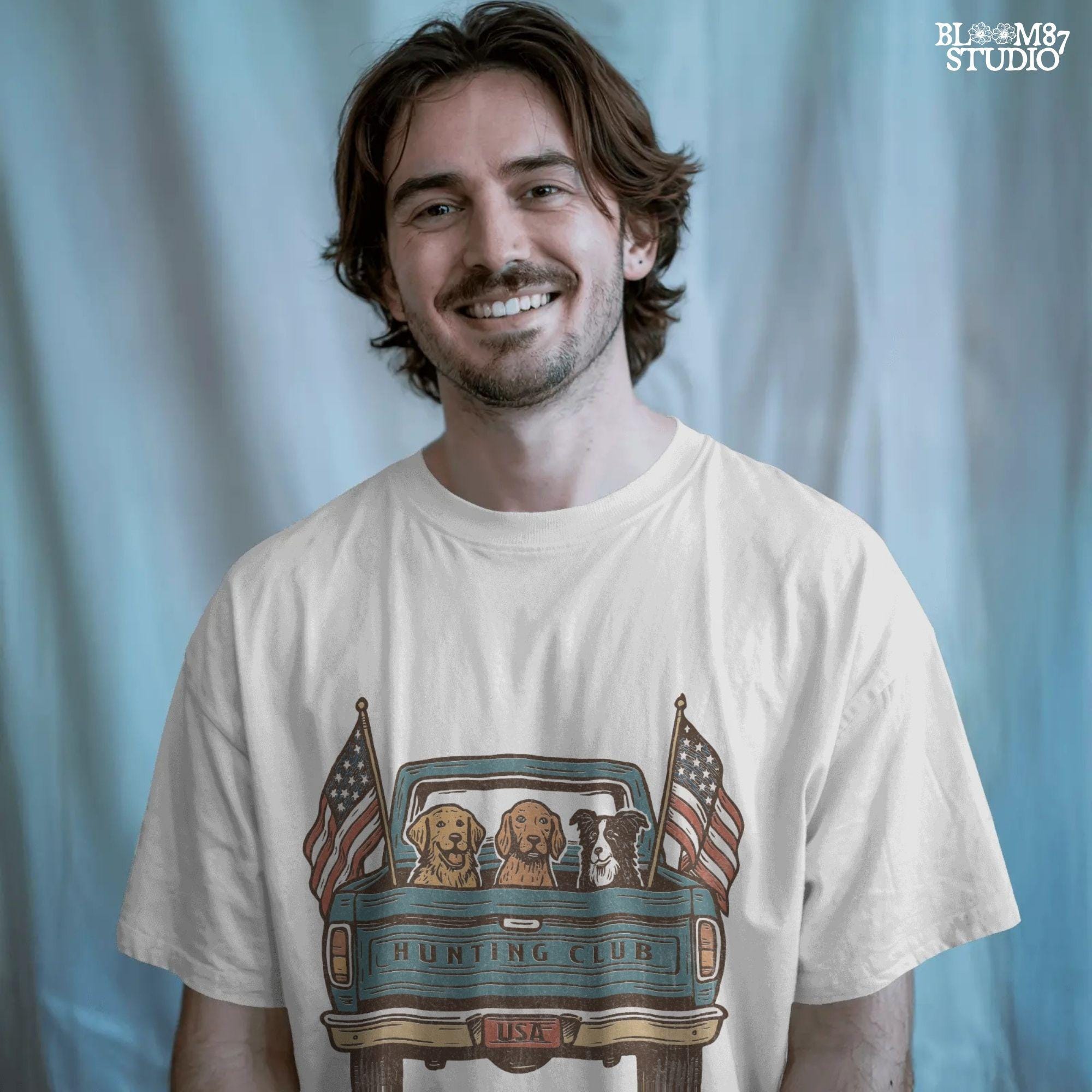 Three hunting dogs in the back of a blue vintage pickup truck with USA flags and “Hunting Club” text, patriotic hunting design for dog lovers.