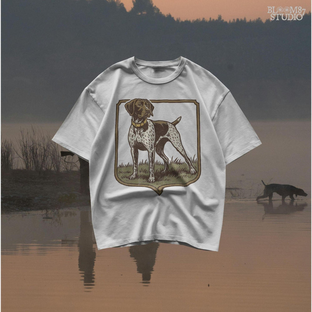 Vintage illustration of a German Shorthaired Pointer standing in grass with a framed border – rustic hunting dog PNG for sublimation.