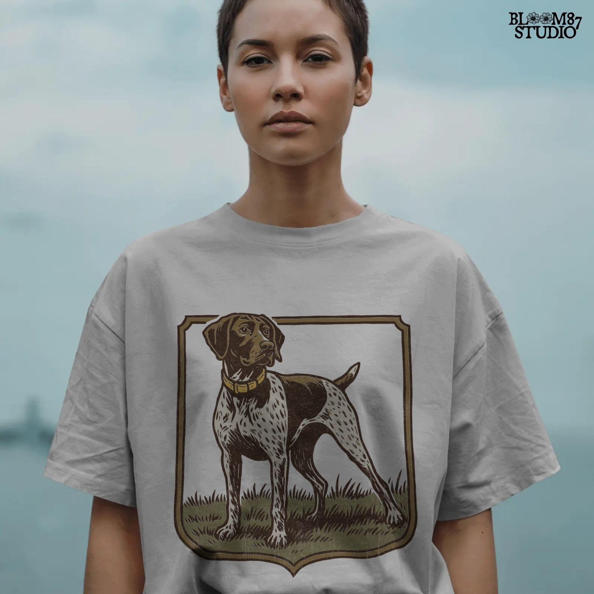 Vintage illustration of a German Shorthaired Pointer standing in grass with a framed border – rustic hunting dog PNG for sublimation.
