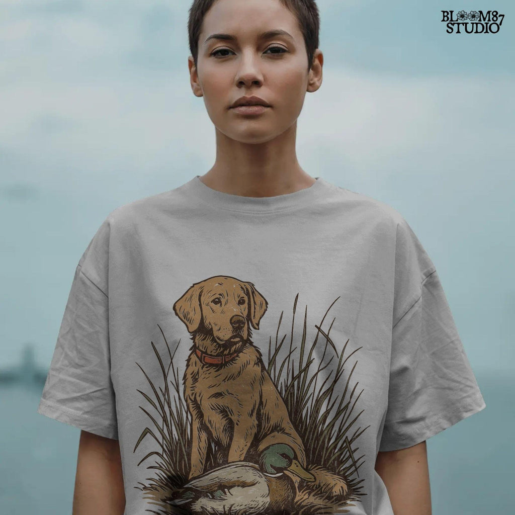 Vintage illustration of a golden Labrador Retriever sitting in grass beside a mallard duck – rustic hunting dog PNG for sublimation and crafts.