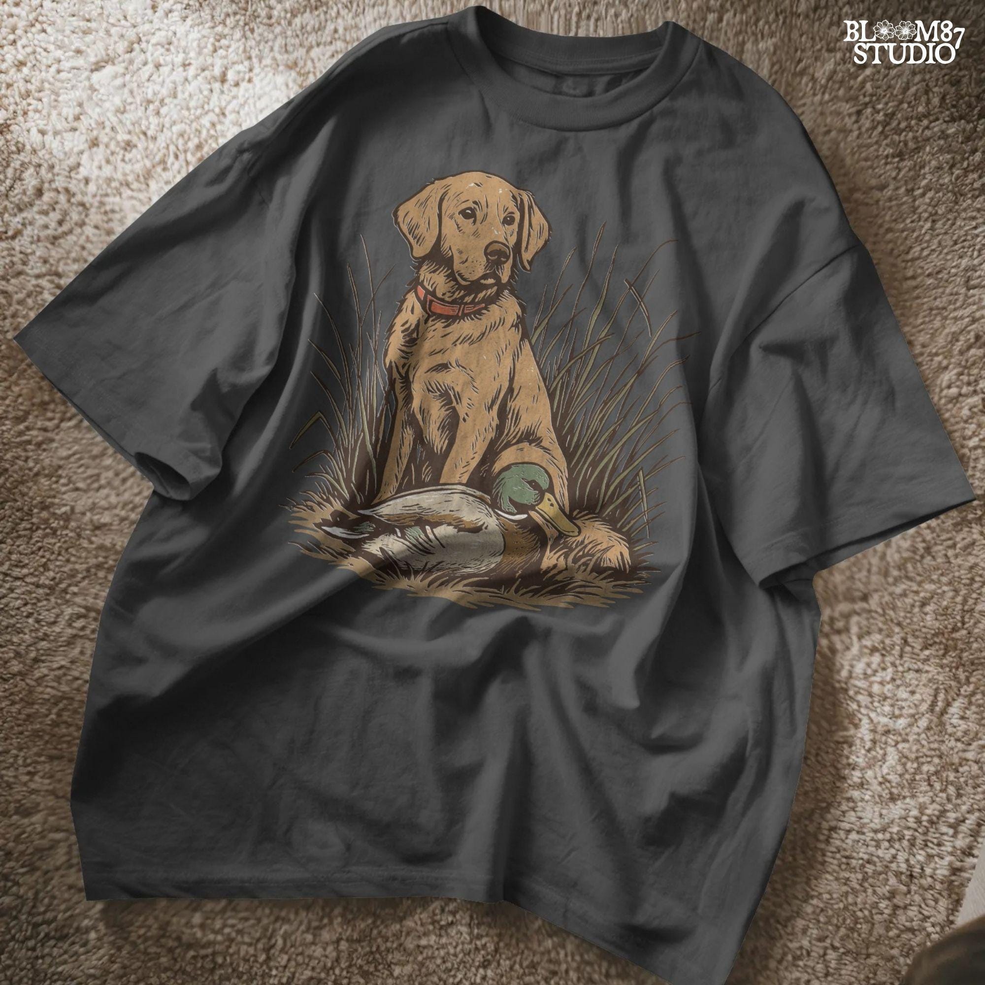 Vintage illustration of a golden Labrador Retriever sitting in grass beside a mallard duck – rustic hunting dog PNG for sublimation and crafts.