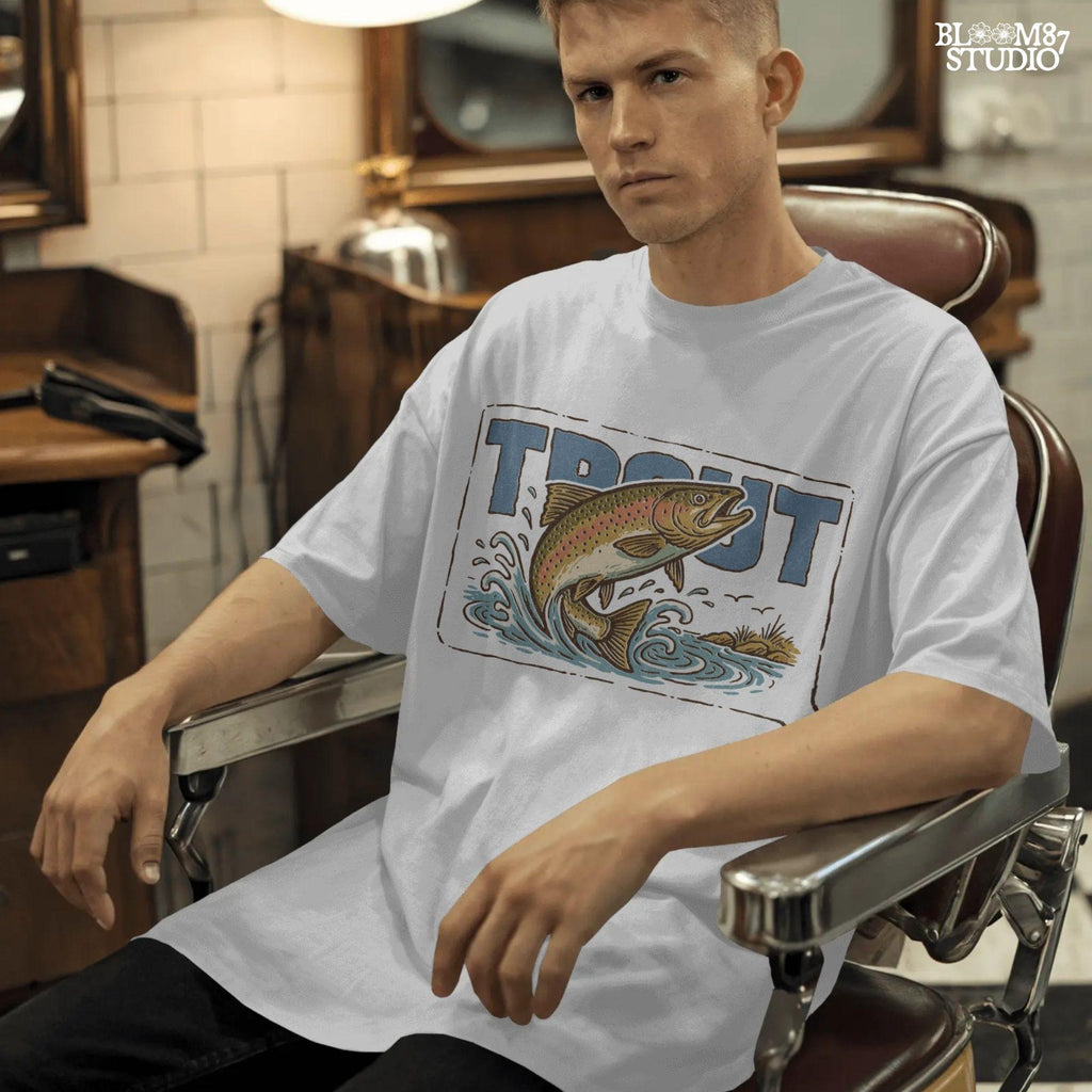 Vintage-style illustration of a rainbow trout jumping from the water in front of bold block letters spelling “TROUT”.