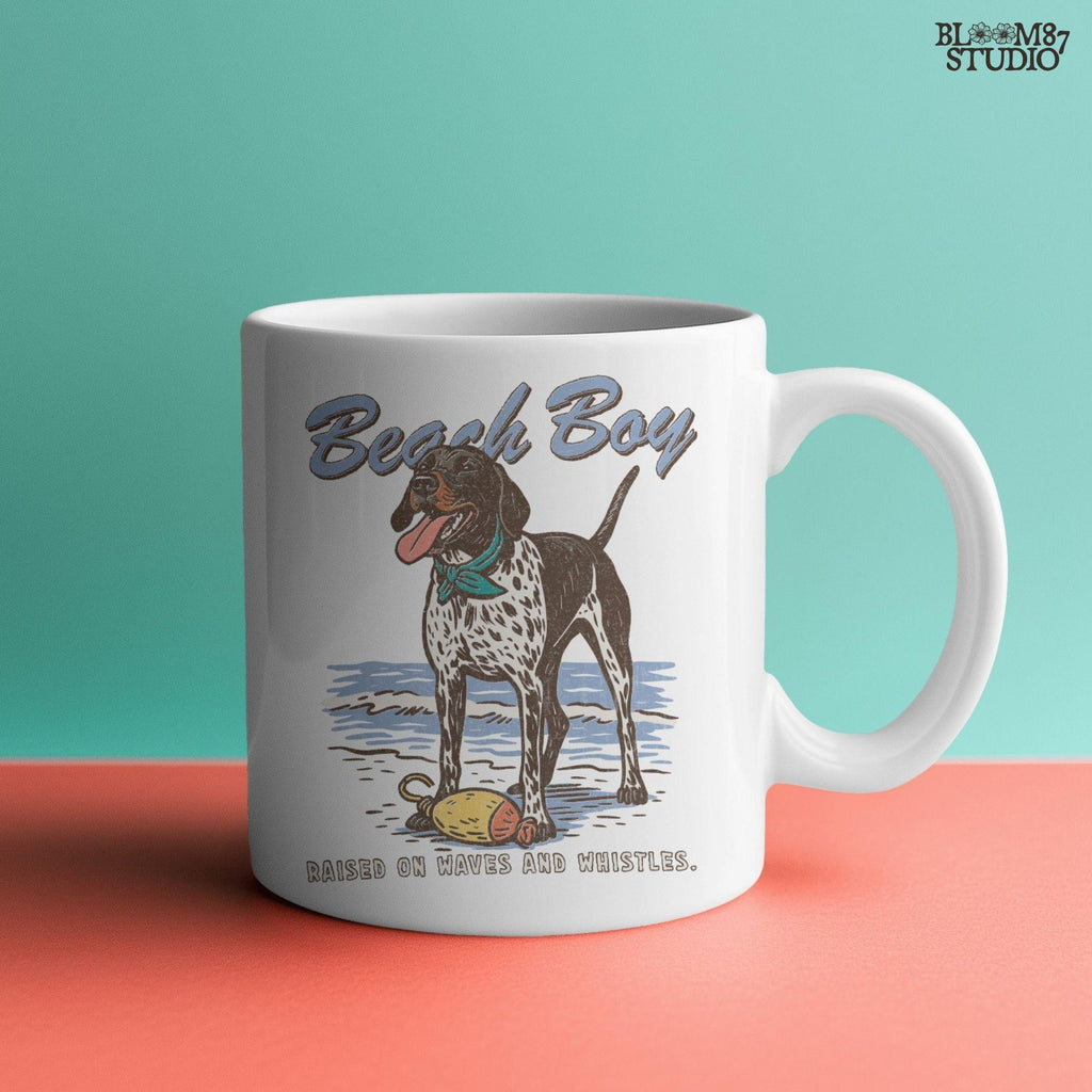 Vintage-style German Shorthaired Pointer standing on the beach with a buoy toy, text reads “Beach Boy – Raised on Waves and Whistles” – summer dog PNG.