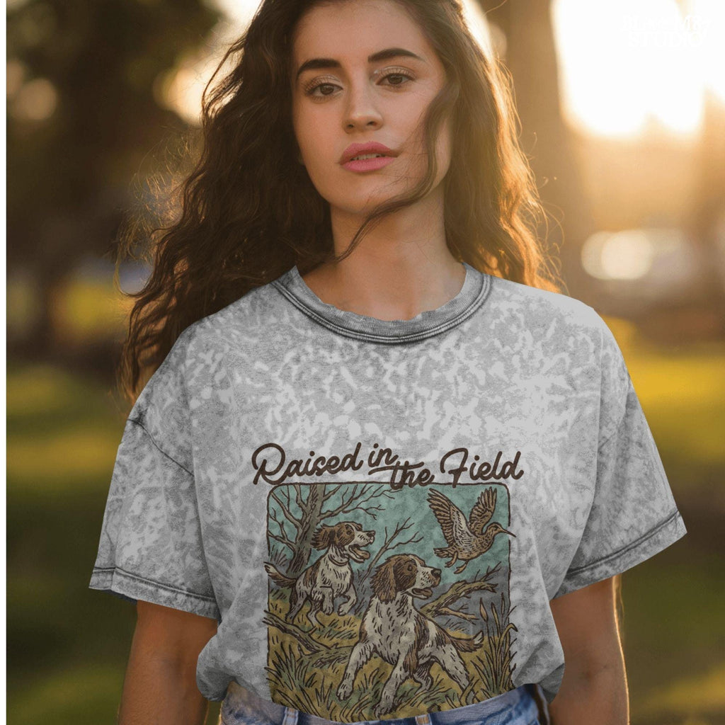 Rustic illustration of two Springer Spaniels flushing a game bird with the phrase “Raised in the Field” in vintage script.