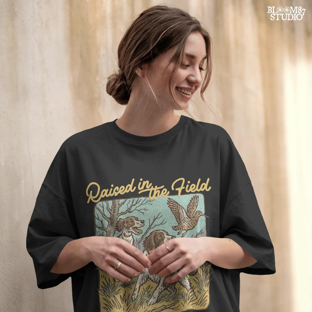 Rustic illustration of two Springer Spaniels flushing a game bird with the phrase “Raised in the Field” in vintage script.