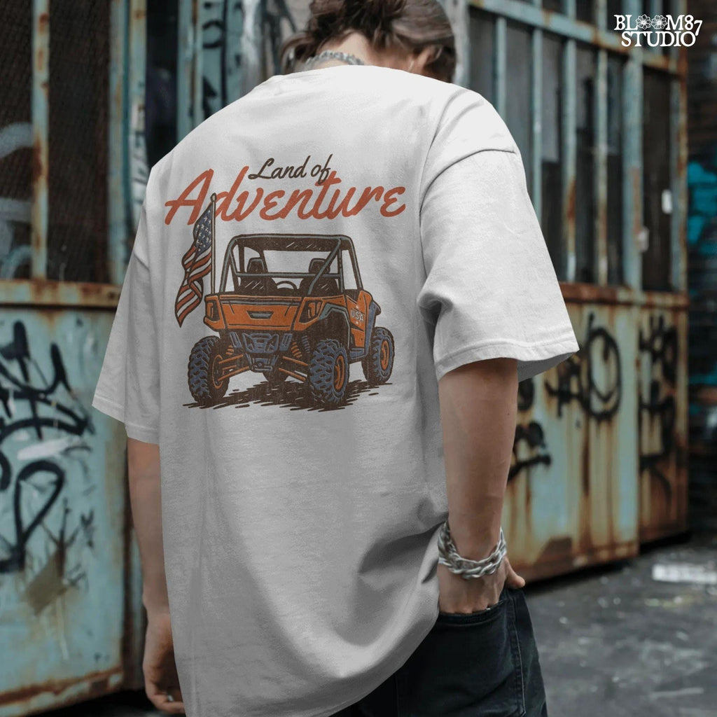 Off-road UTV with American flag driving on a dirt trail, text reads “Land of Adventure” – patriotic outdoor sublimation PNG design.