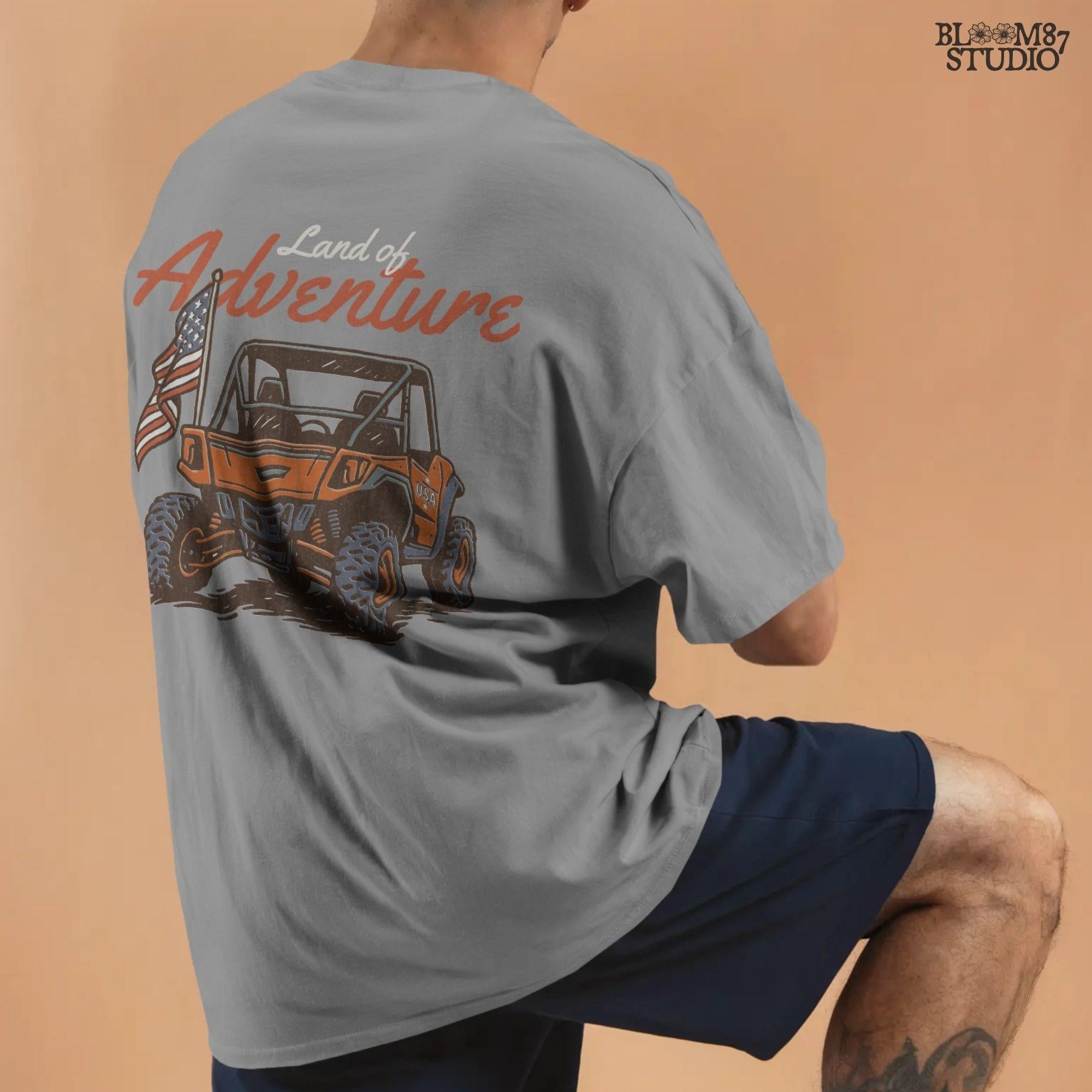 Off-road UTV with American flag driving on a dirt trail, text reads “Land of Adventure” – patriotic outdoor sublimation PNG design.
