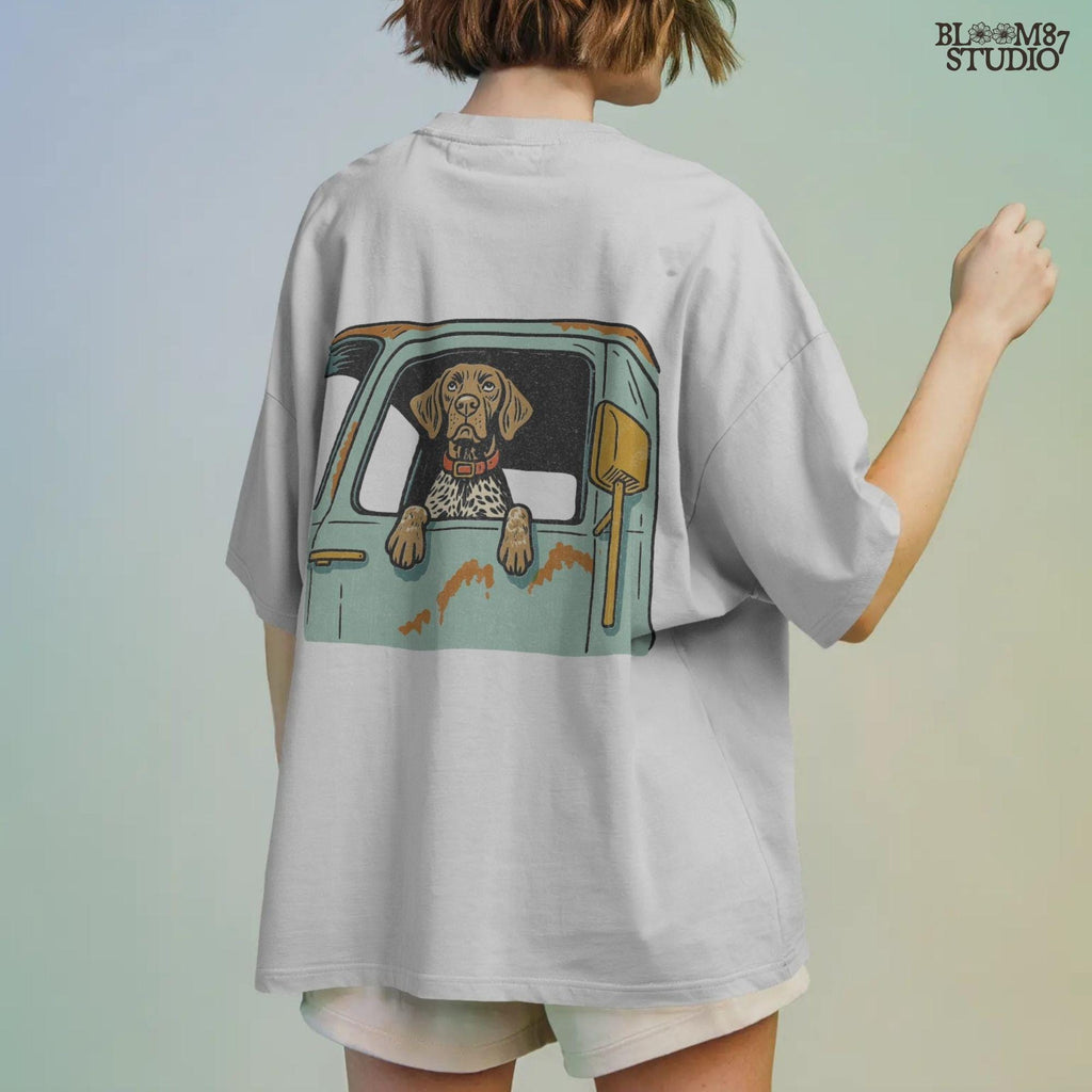 Vintage-style German Shorthaired Pointer with front paws out an old farm truck window – rustic hunting dog sublimation PNG.