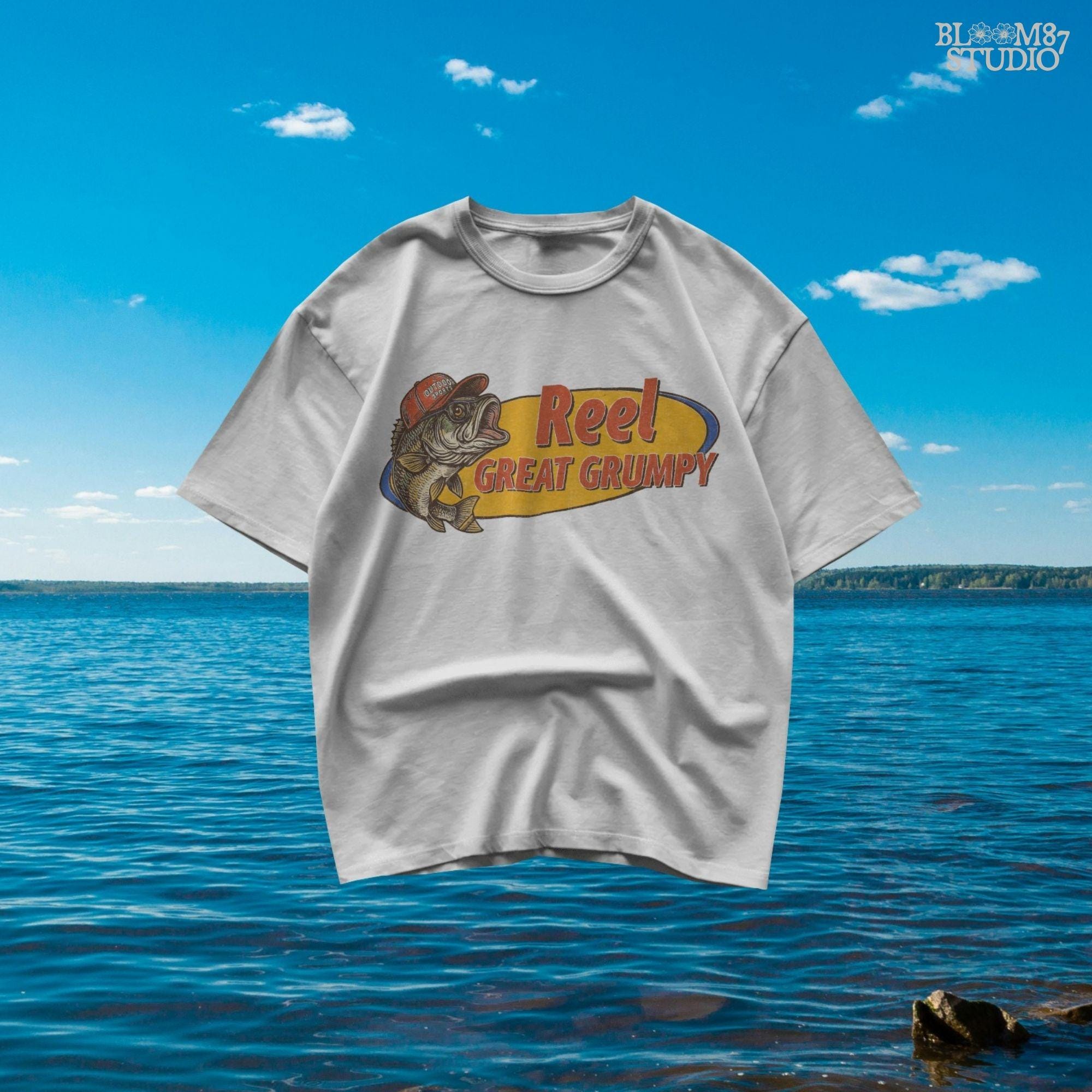 Retro-style grumpy bass fish wearing a red outdoor hat with bold text “Reel Great Grumpy” on a yellow and orange background