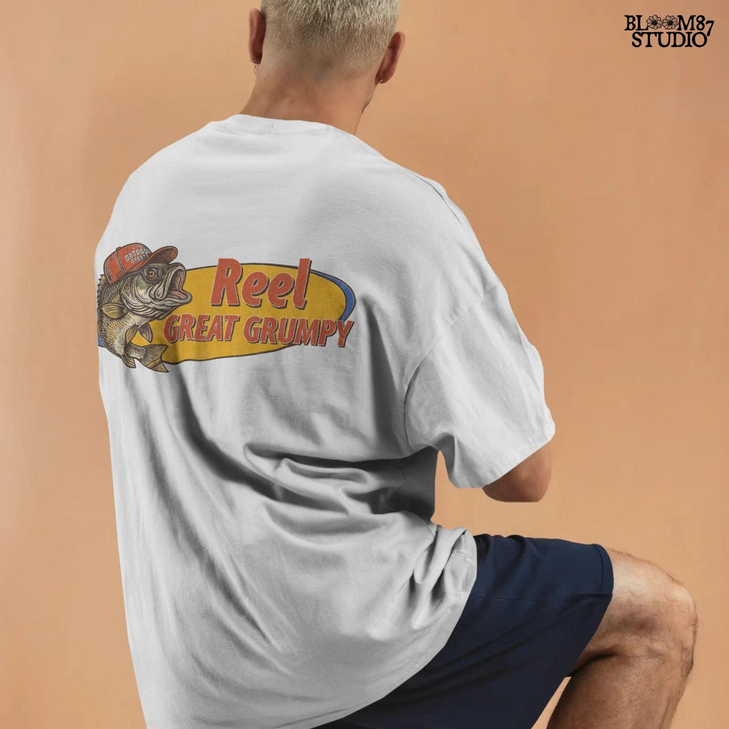 Retro-style grumpy bass fish wearing a red outdoor hat with bold text “Reel Great Grumpy” on a yellow and orange background