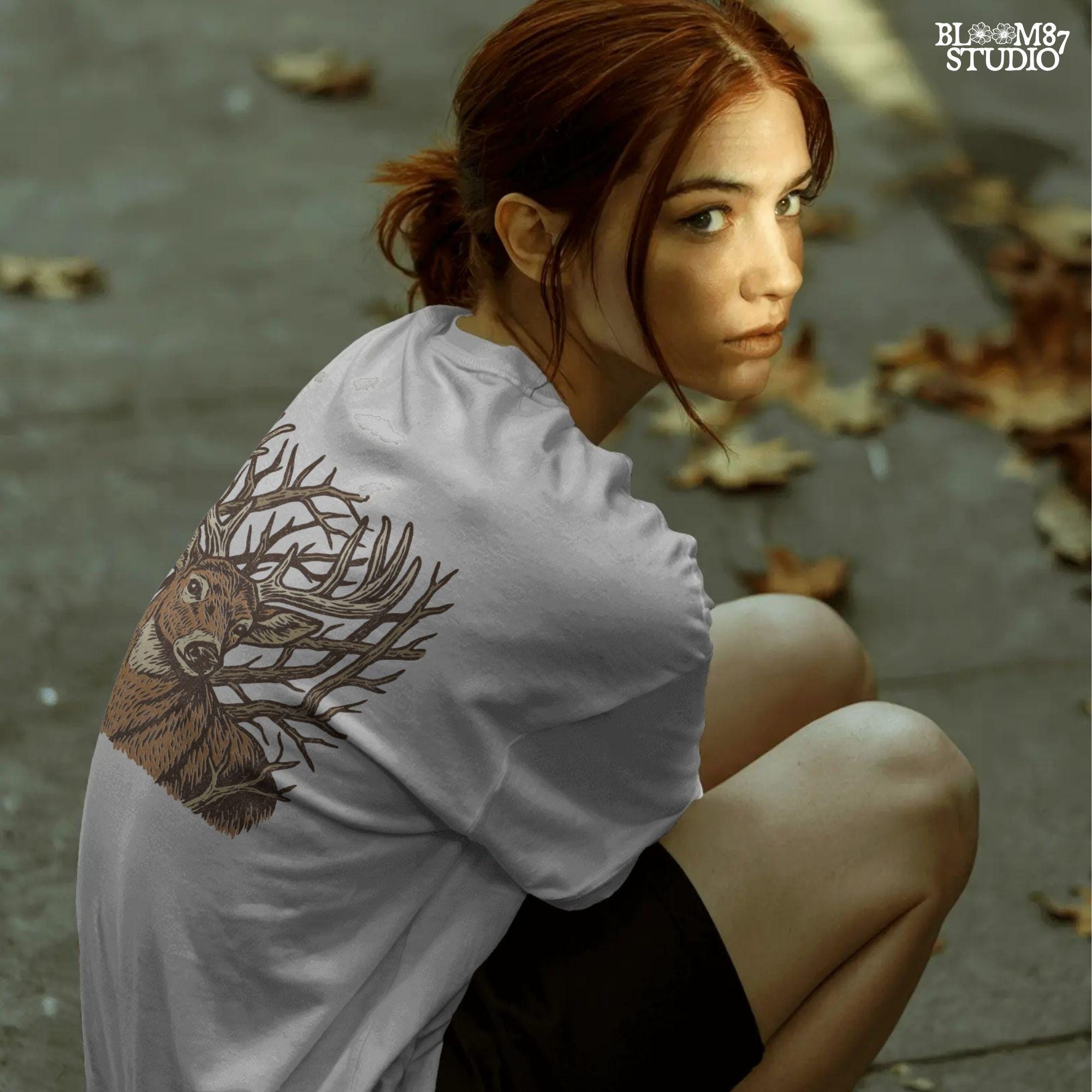 Hand-drawn whitetail deer with large antlers surrounded by bare woodland branches in earthy brown tones on a transparent background.