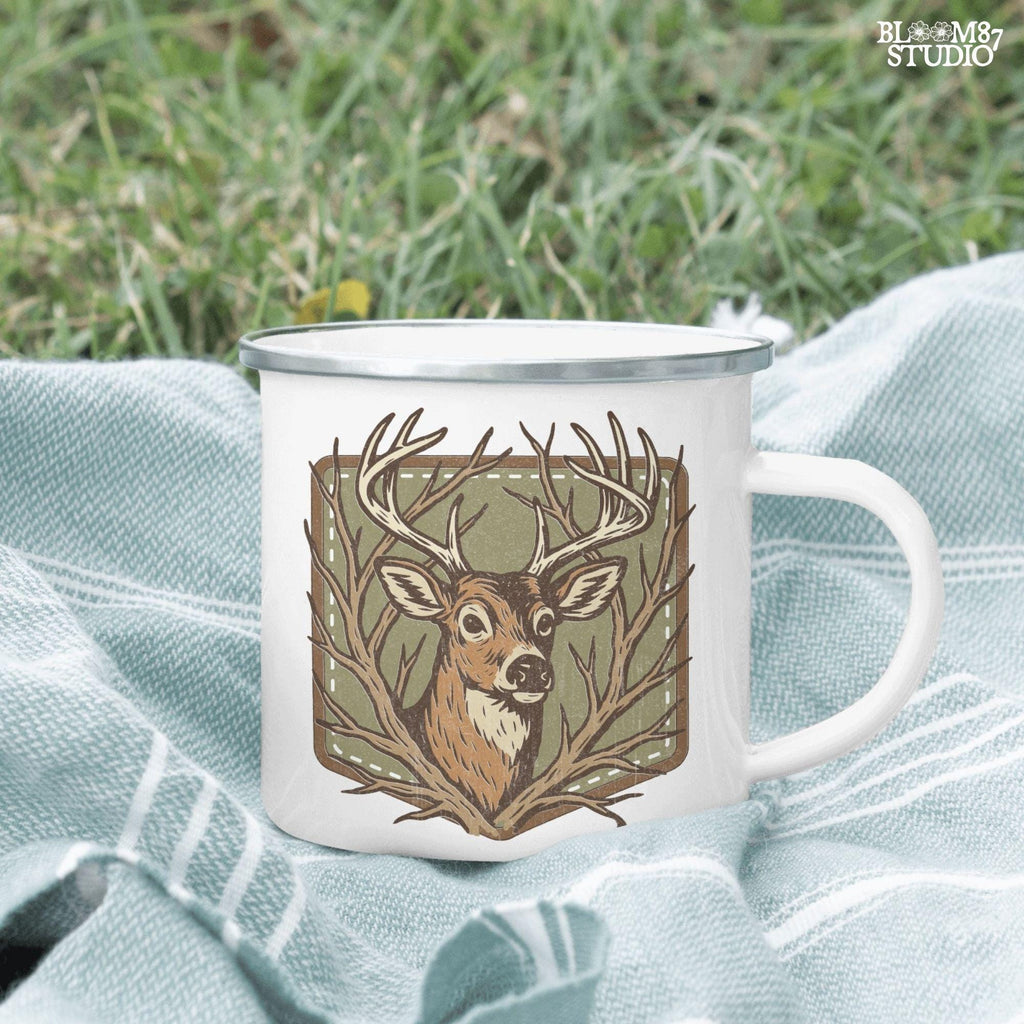 Stylized deer head with antlers framed by bare branches, placed on an olive green patch background with stitching detail.