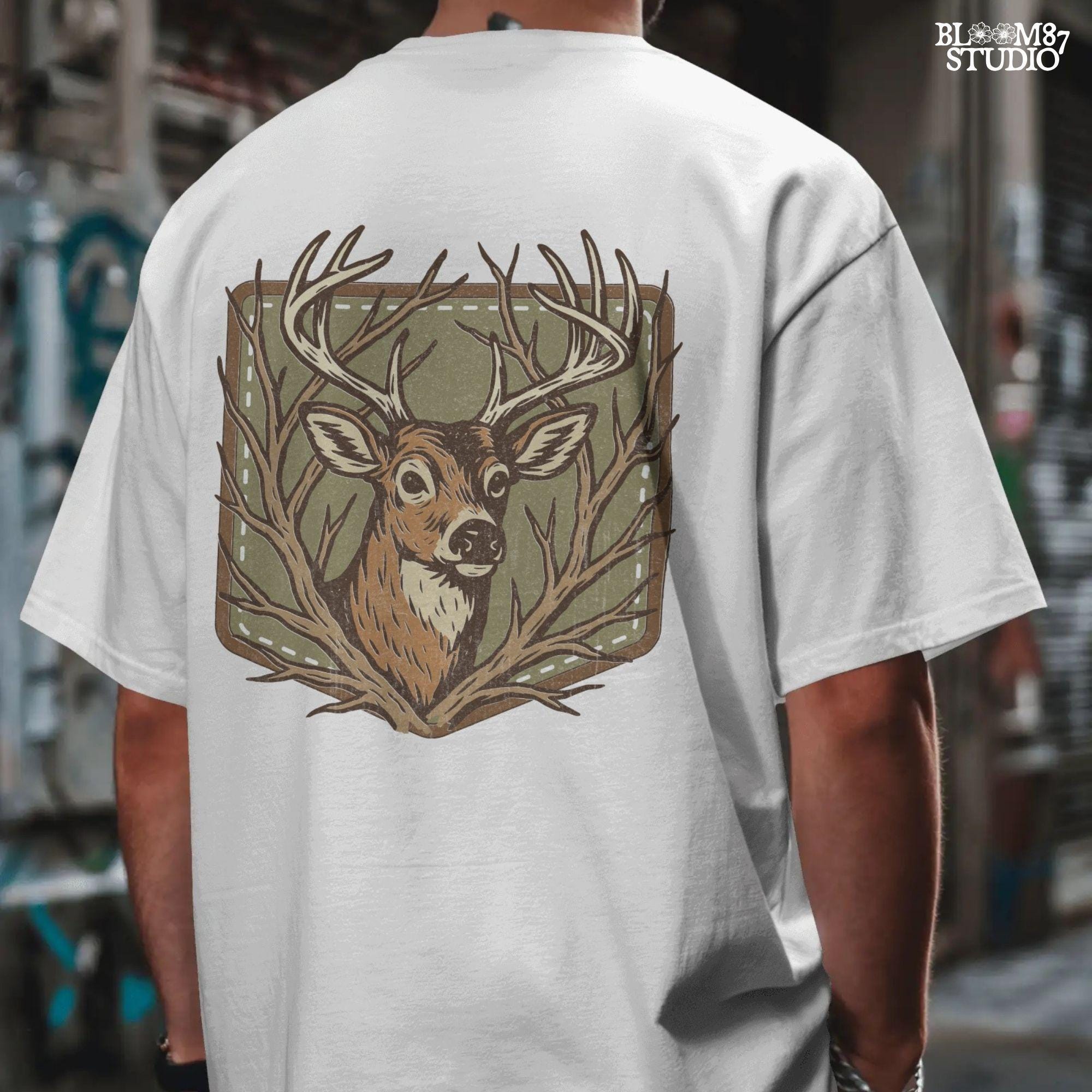 Stylized deer head with antlers framed by bare branches, placed on an olive green patch background with stitching detail.