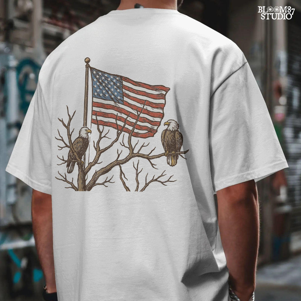 Two bald eagles perched on leafless tree branches in front of a waving American flag in a vintage-style illustration.