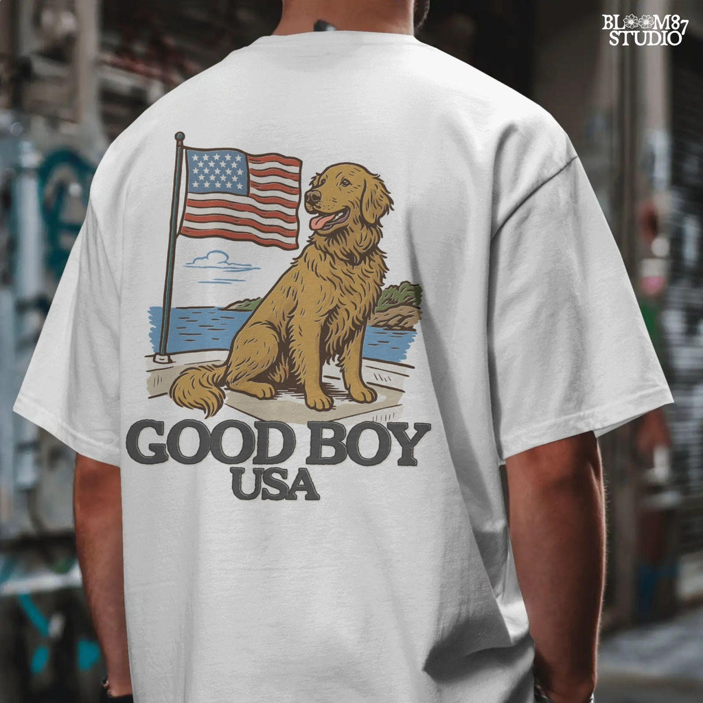 Golden retriever sitting proudly in front of the American flag with “Good Boy USA” text below, patriotic dog design