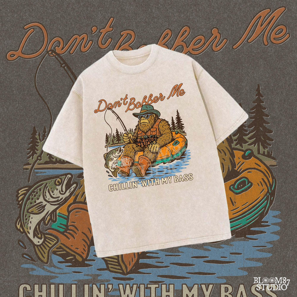 Funny Bigfoot sitting in a float tube holding a fishing rod and bass fish, wearing sunglasses and vest, with text “Don’t Bobber Me – Chillin’ with My Bass.”