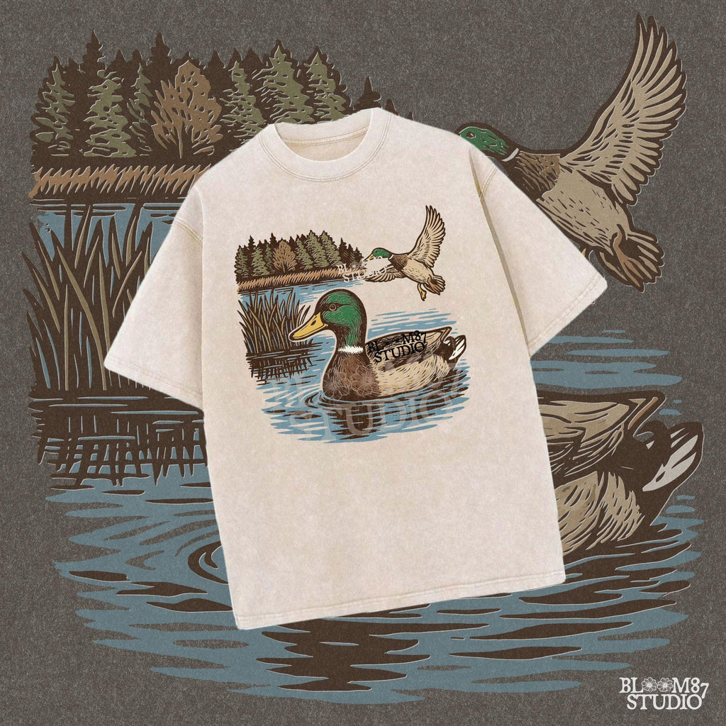 Two mallard ducks in a peaceful summer lake scene with pine trees and blue water, one swimming and one flying.