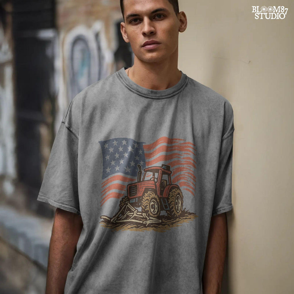 Red tractor with plow on soil, American flag waving in the background, vintage farm-themed graphic.